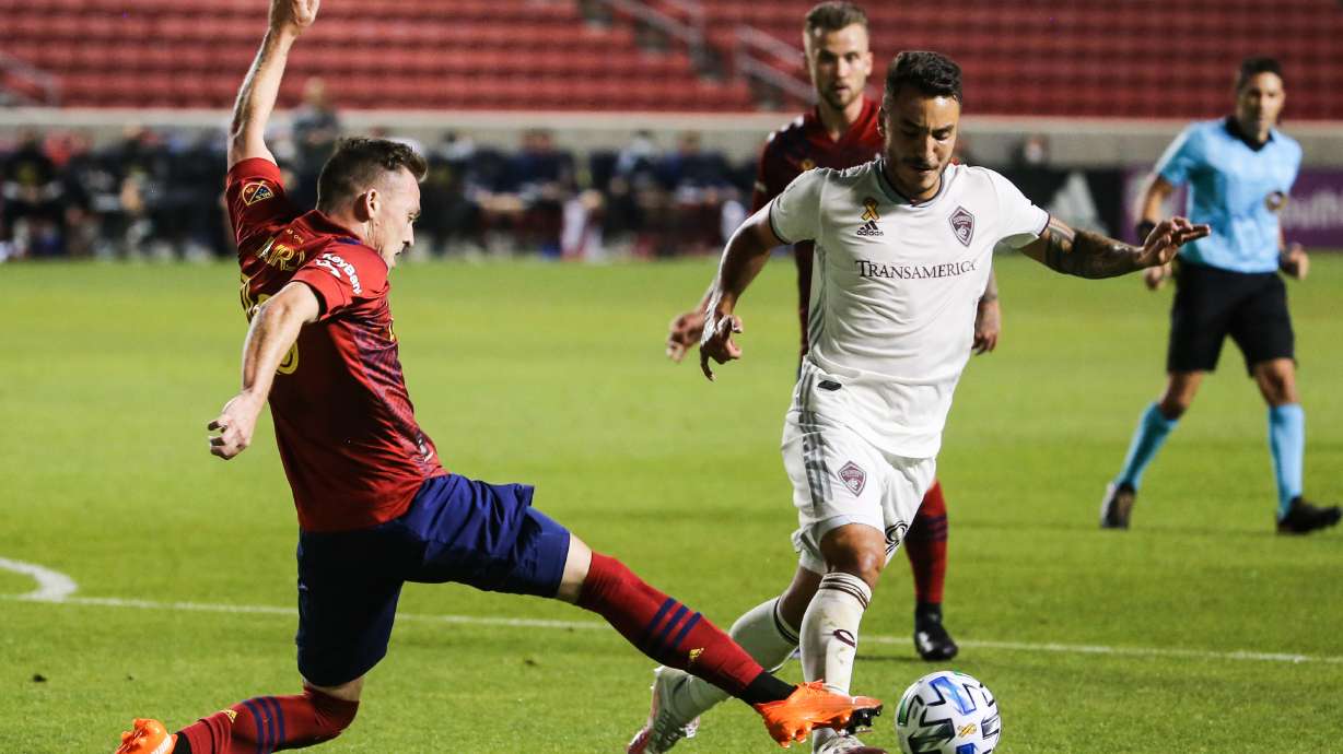 Real Salt Lake forward Corey Baird (10) tackles Colorado Rapids forward Andre Shinyashiki (99) during an MLS soccer game at Rio Tinto Stadium in Sandy on Saturday, Sept. 12, 2020.