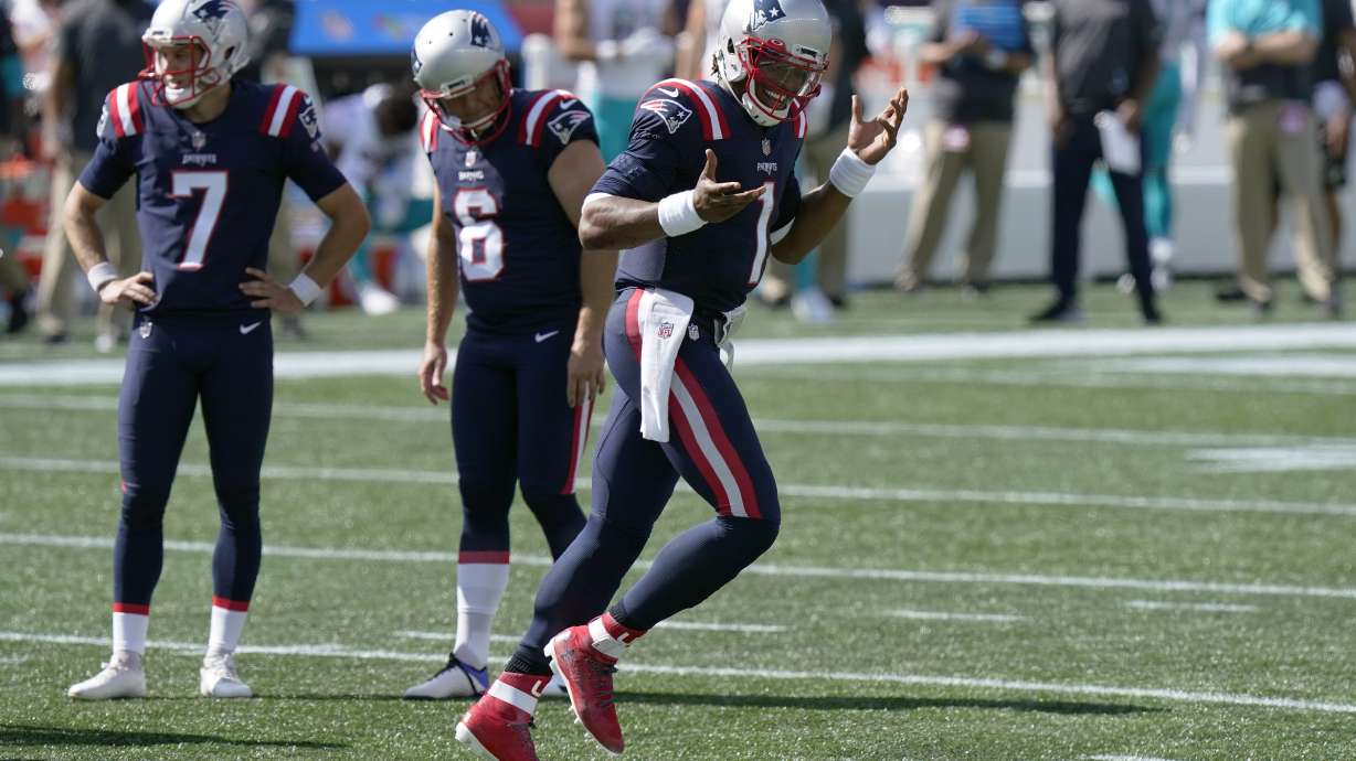 Newton runs for 2 TDs, Patriots hold off Dolphins 21-11