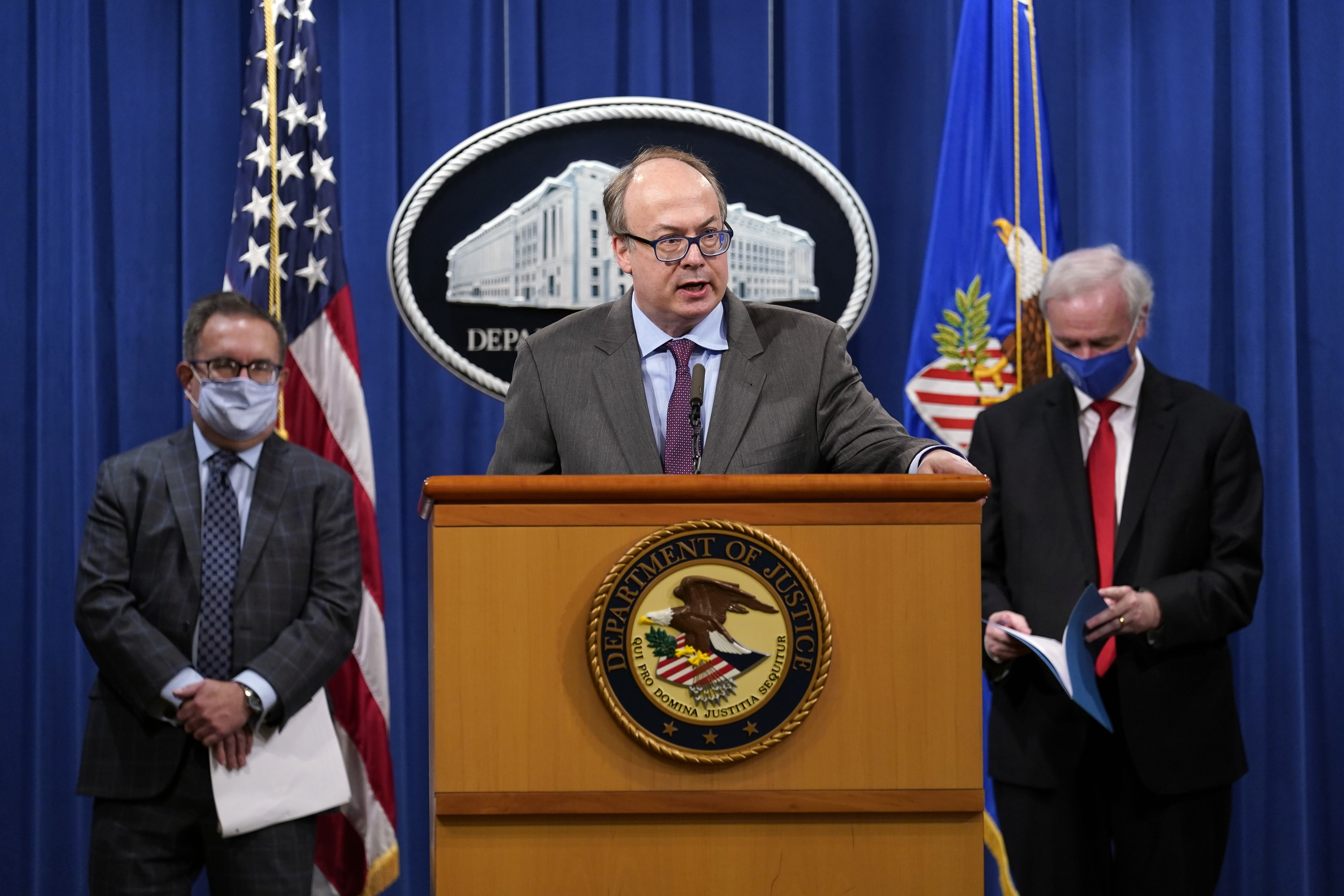 Jeff Clark, Assistant Attorney General for the Environment and Natural Resources Division, speaks as Deputy Attorney General Jeffrey Rosen, right, and Environmental Protection Agency (EPA) Administrator Andrew Wheeler, left, look on during a news conference at the Justice Department in Washington, Monday, Sept. 14, 2020. Automakers Daimler AG and subsidiary Mercedes-Benz USA have agreed to pay $1.5 billion to the U.S. government and California state regulators to resolve emissions cheating allegations. (AP Photo/Susan Walsh, Pool) [Sep-14-2020]