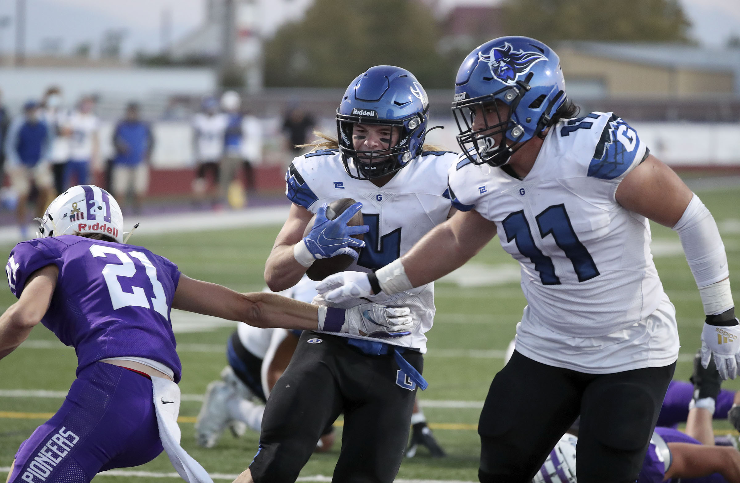 Pleasant Grove's Rex Connors scores a touchdown between Lehi's Kadiyon Sweat and Pleasant Grove's Spencer Tauteoli during a football game at Lehi High School in Lehi on Friday, Sept. 11, 2020