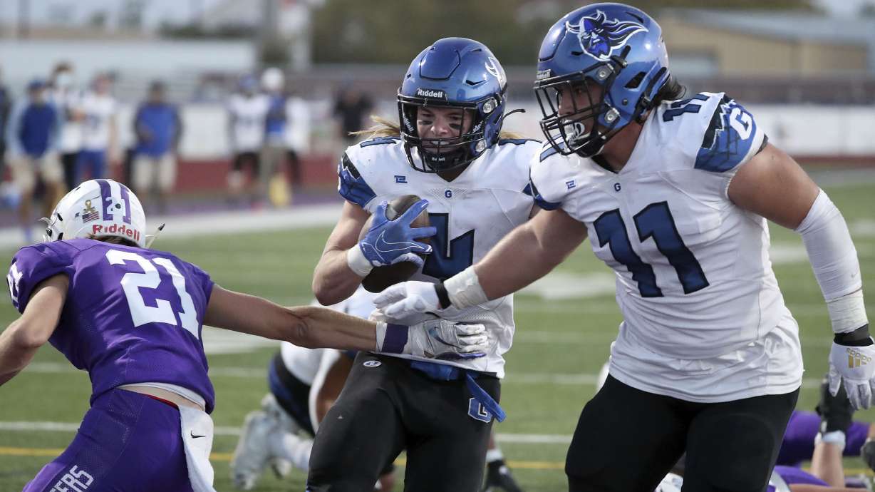 Pleasant Grove's Rex Connors scores a touchdown between Lehi's Kadiyon Sweat and Pleasant Grove's Spencer Tauteoli during a football game at Lehi High School in Lehi on Friday, Sept. 11, 2020