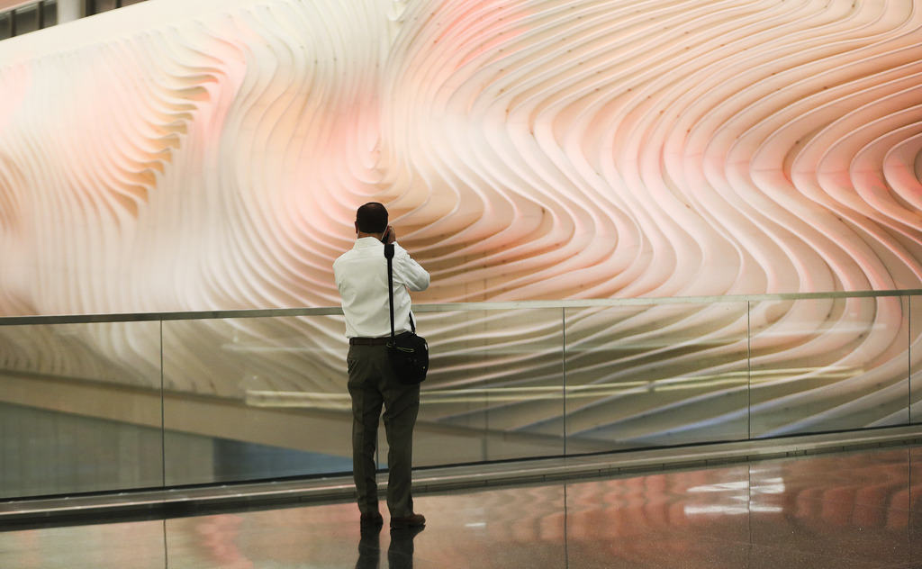 Jeff Young takes a photo of “The Canyon, ” an art installation by Gordon Huether, during the first phase opening of the new Salt Lake City International Airport in Salt Lake City on Tuesday, Sept. 15, 2020.