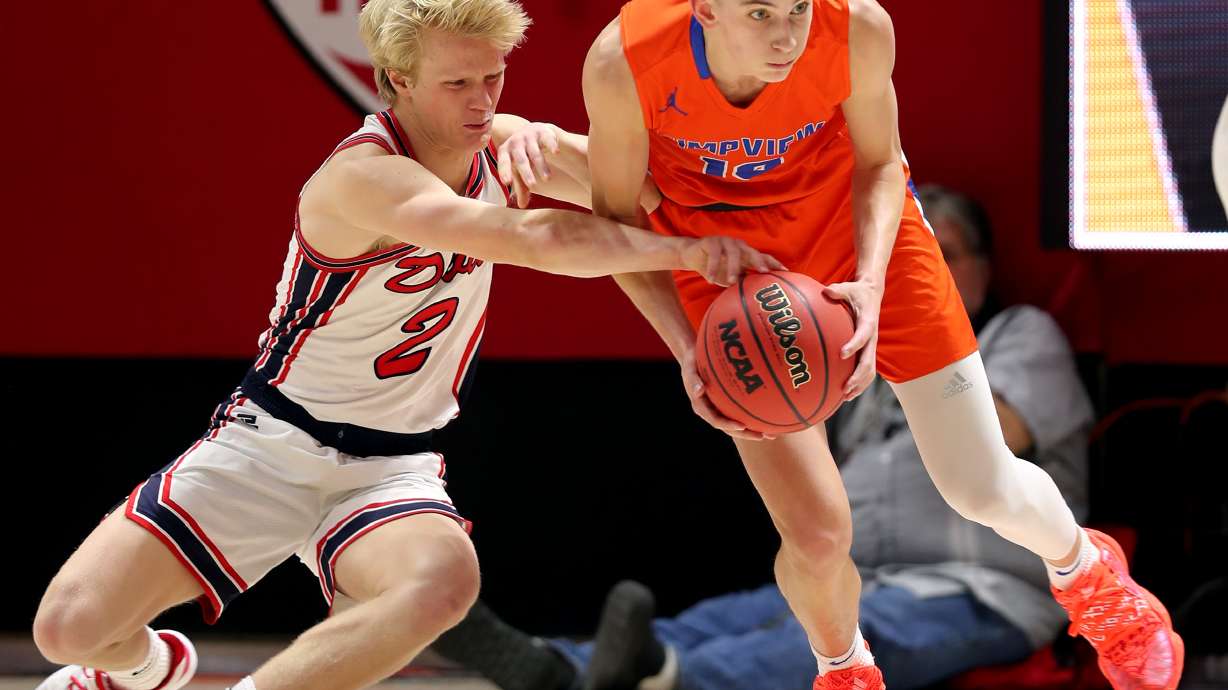 Springville’s Austin Mortensen tries to knock the ball away from Timpview’s Jake Wahlin as the two teams play in the 5A boys state basketball championship in the Huntsman Center in Salt Lake City on Saturday, Feb. 29, 2020. Springville won 66-53.