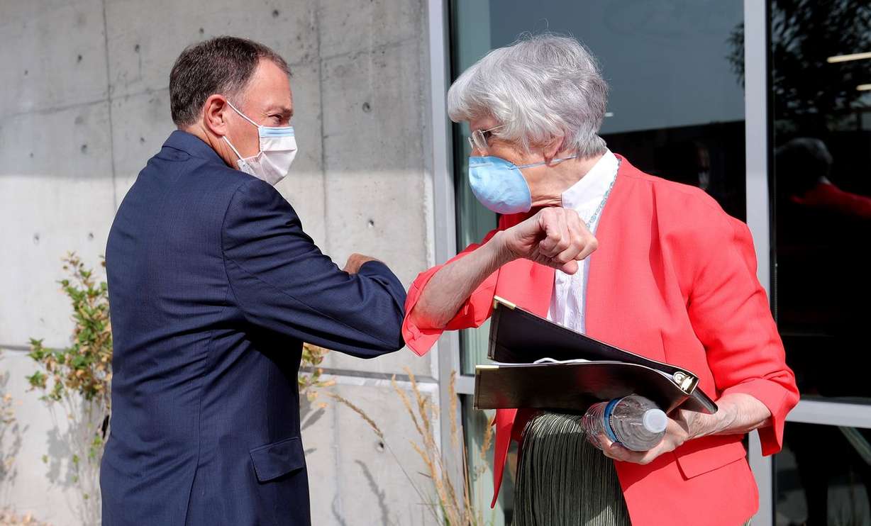 Gov. Gary Herbert and Pamela Atkinson bump elbows at a ribbon-cutting ceremony for Pamela’s Place Apartments in Salt Lake City on Tuesday, Sept. 15, 2020. The Housing Authority of Salt Lake City's newest, permanent supportive housing development is named after Atkinson, a longtime community advocate for people experiencing homelessness.