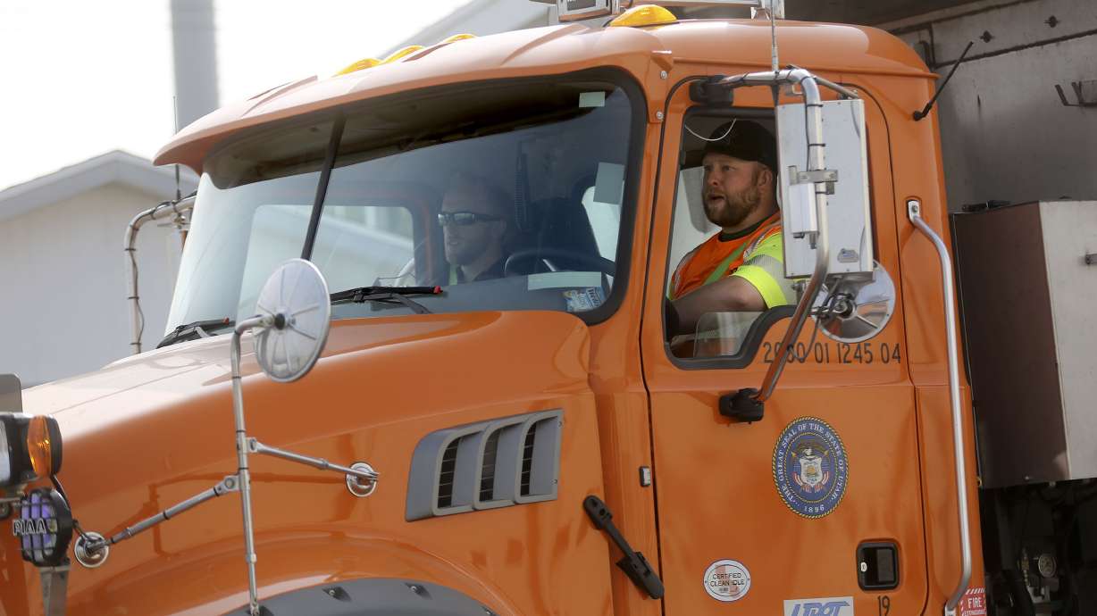 Utah Department of Transportation technicians Kurt O’Neal, left, and Colby Larsen leave a UDOT press conference in Murray to go pick up windstorm debris in the Rose Park neighborhood of Salt Lake City on Wednesday, Sept. 16, 2020. O’Neal was sitting in the driver’s seat of a UDOT truck as Larsen was picking up trash behind the truck on the side of I-15 this summer when another vehicle struck their truck, narrowly missing Larsen.