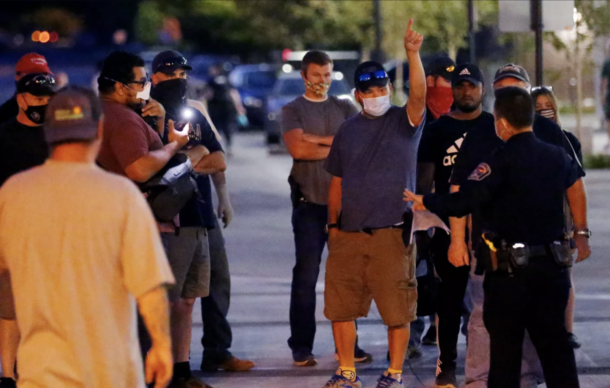 Counterprotesters try to get police to remove a man taking video of them during a demonstration at the West Valley City Police Department on Wednesday, Sept. 16, 2020.