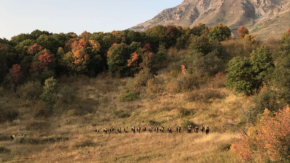 Firefighters are seen returning to their base camp near the Battle Creek 2 Fire in Utah County on Wednesday, Sept. 16, 2020.