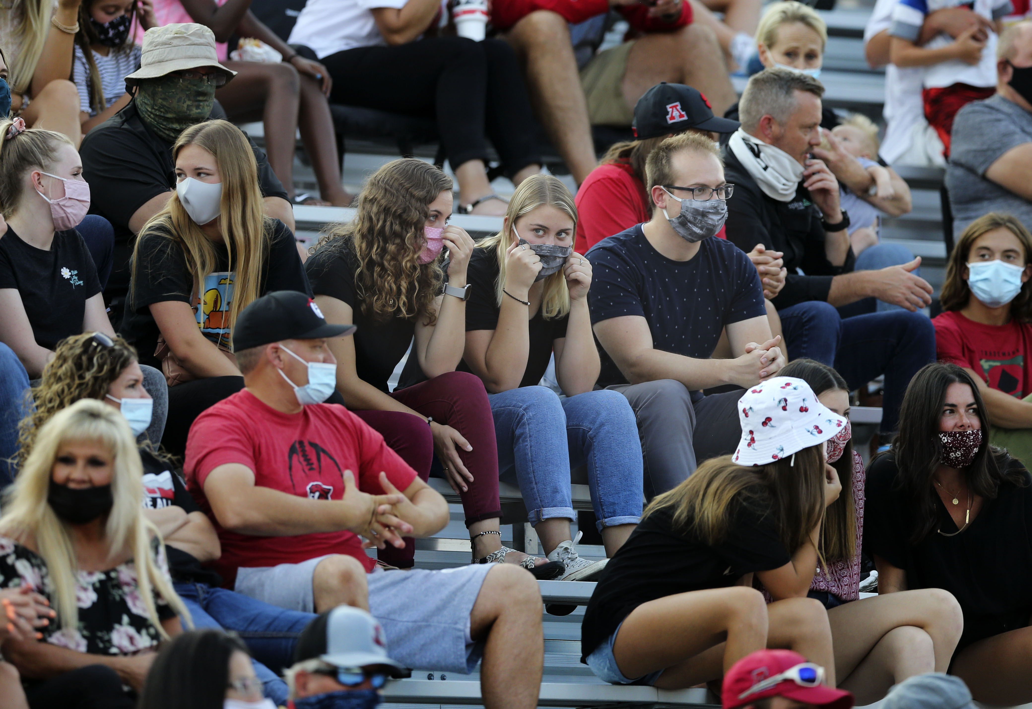 Spectators wear masks while watching the American Fork vs. Timpview high school football game in American Fork on Thursday, Aug. 20, 2020.