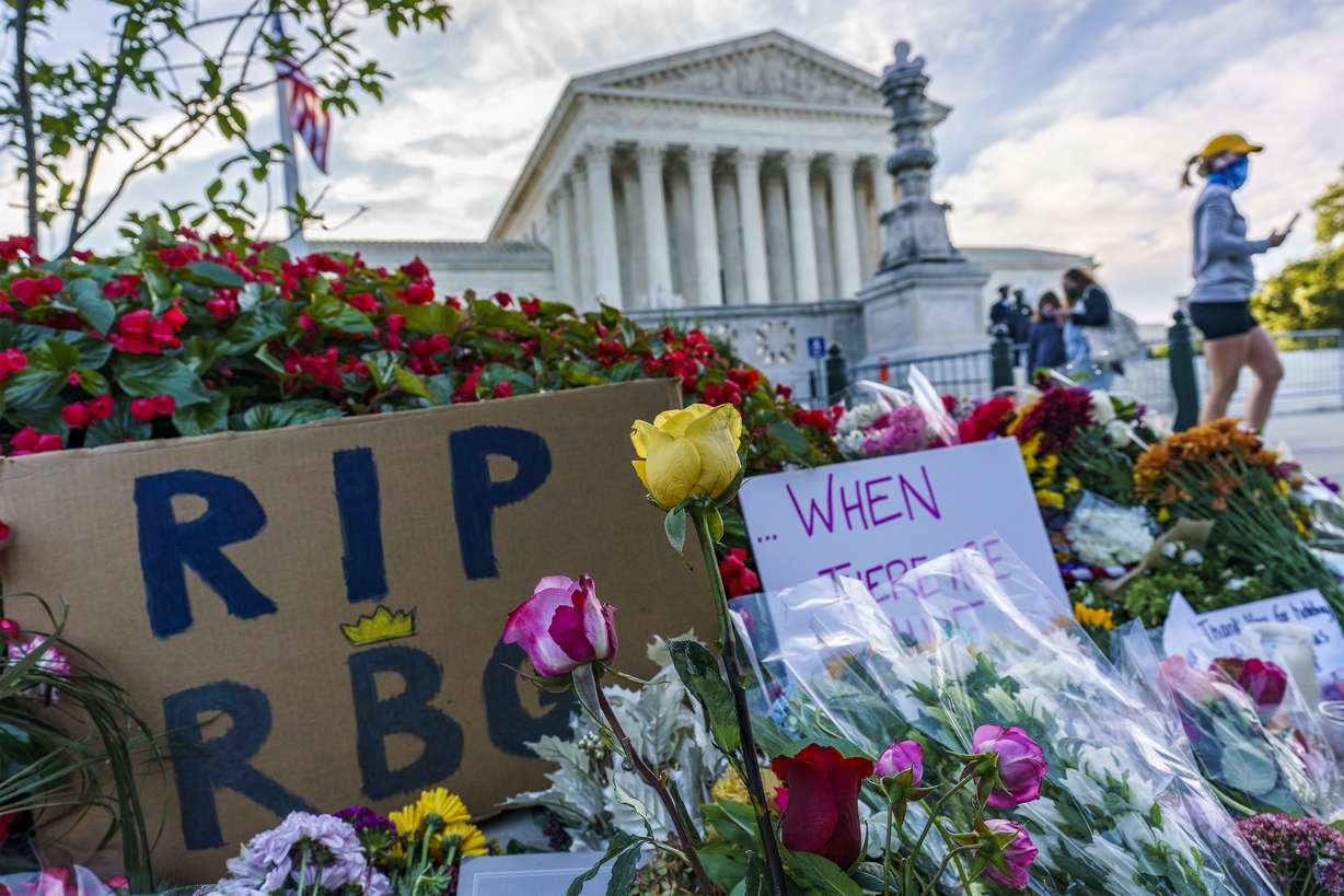 People gather at the Supreme Court on the morning after the death of Justice Ruth Bader Ginsburg, 87, Saturday, Sept. 19, 2020 in Washington.