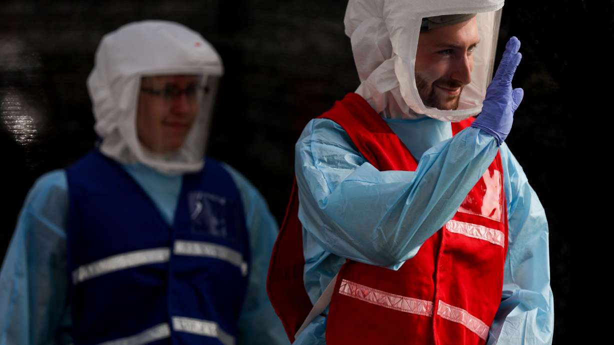 Seth Christensen waves goodbye after administering a COVID-19 test at a testing site run by the Salt Lake County Health Department at Glendale Middle School in Salt Lake City on Tuesday, Sept. 15, 2020.