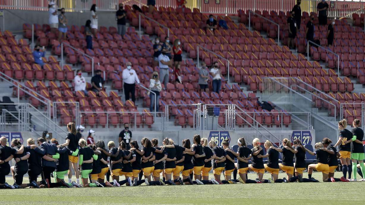 The majority of the Utah Royals team kneels during the national anthem prior to kickoff against the OL Reign before a 2020 NWSL Challenge Cup game at Zions Bank Stadium in Herriman on Wednesday, July 8, 2020.