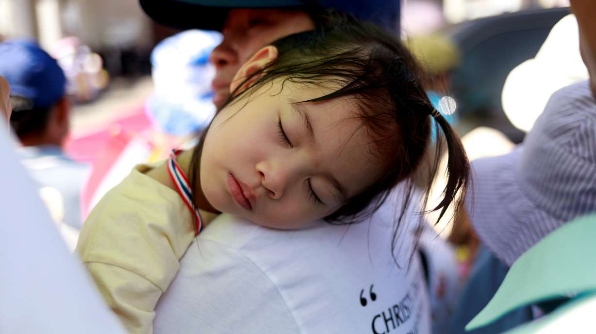 FILE PHOTO: A girl sleeps while waiting for the arrival of Pope Francis at St. Peterâs Parish church in the Sam Phran district of Nakhon Pathom Province, Thailand, November 22, 2019. REUTERS/Jorge Silva/File Photo