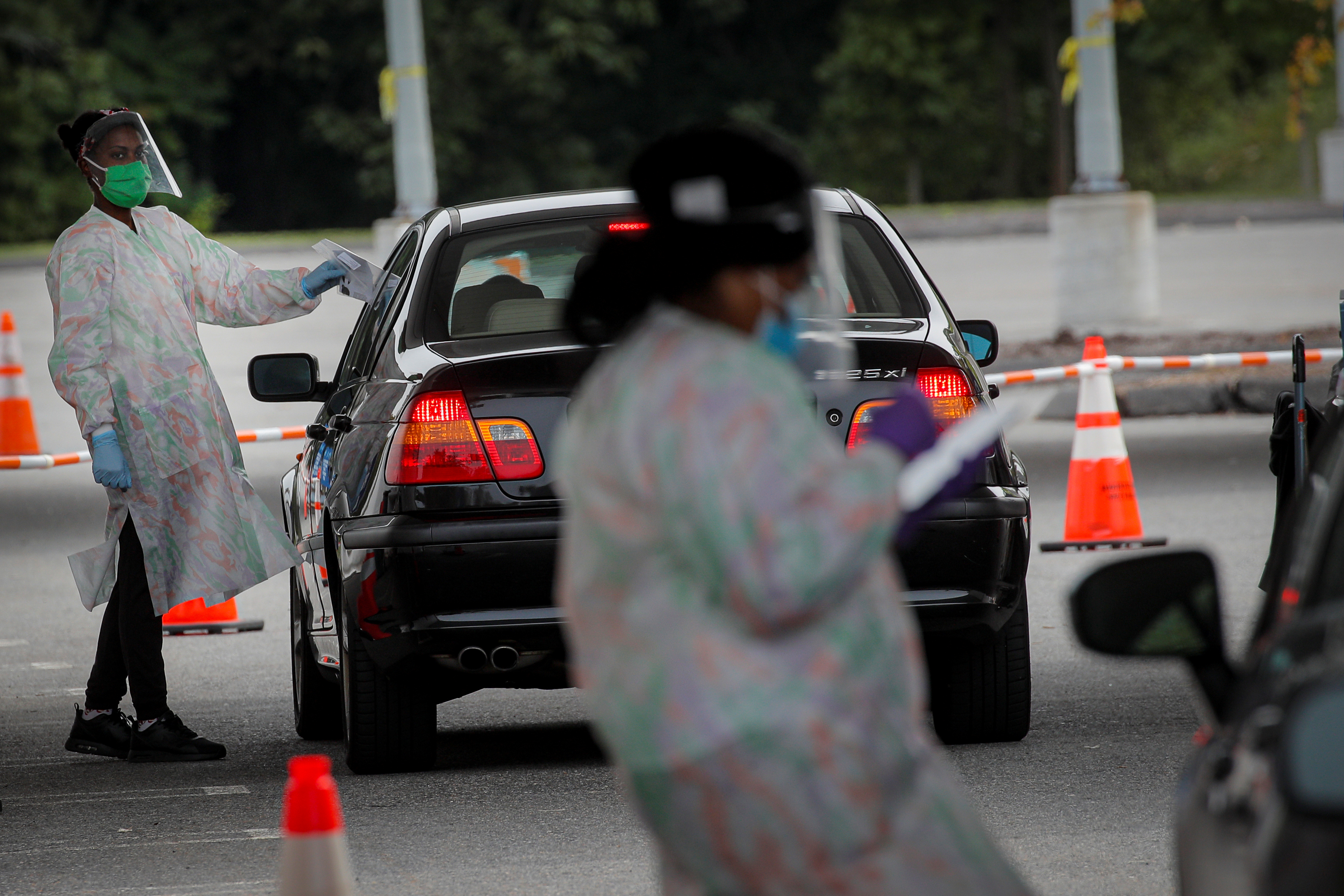Medical technicians work at a drive-thru coronavirus disease (COVID-19) testing facility at the Regeneron Pharmaceuticals company's Westchester campus in Tarrytown, New York, U.S. September 17, 2020.