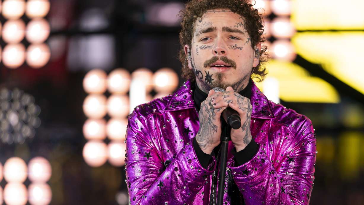 Post Malone performs at the Times Square New Year's Eve celebration in New York on Dec. 31, 2019. Post Malone is bringing his "Twelve Carat Toothache" tour to Salt Lake City in 2022.
