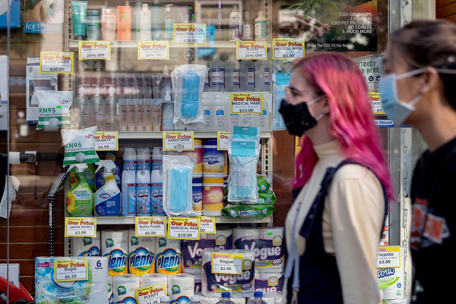 People wearing masks walk past masks being sold as the city continues Phase 4 of re-opening following restrictions imposed to slow the spread of coronavirus on September 18, 2020 in New York City.