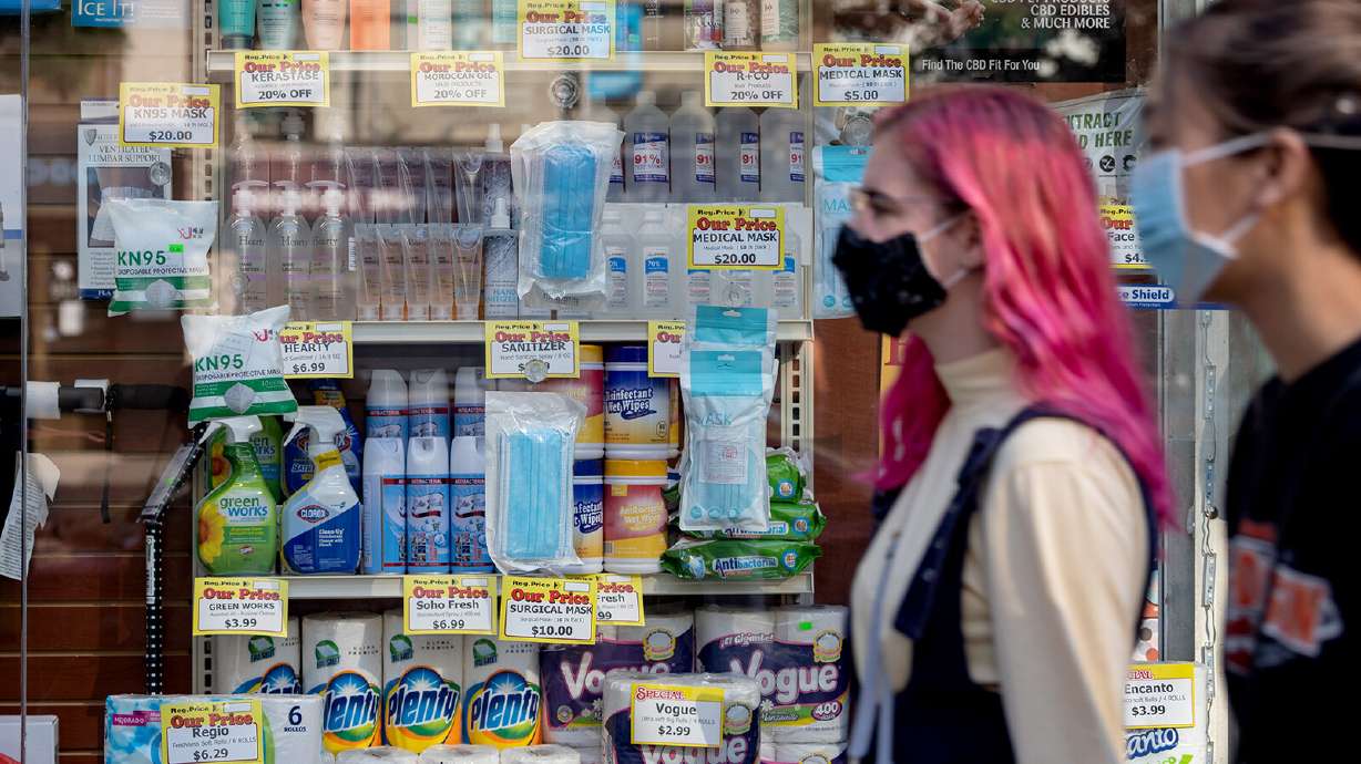 People wearing masks walk past masks being sold as the city continues Phase 4 of re-opening following restrictions imposed to slow the spread of coronavirus on September 18, 2020 in New York City.