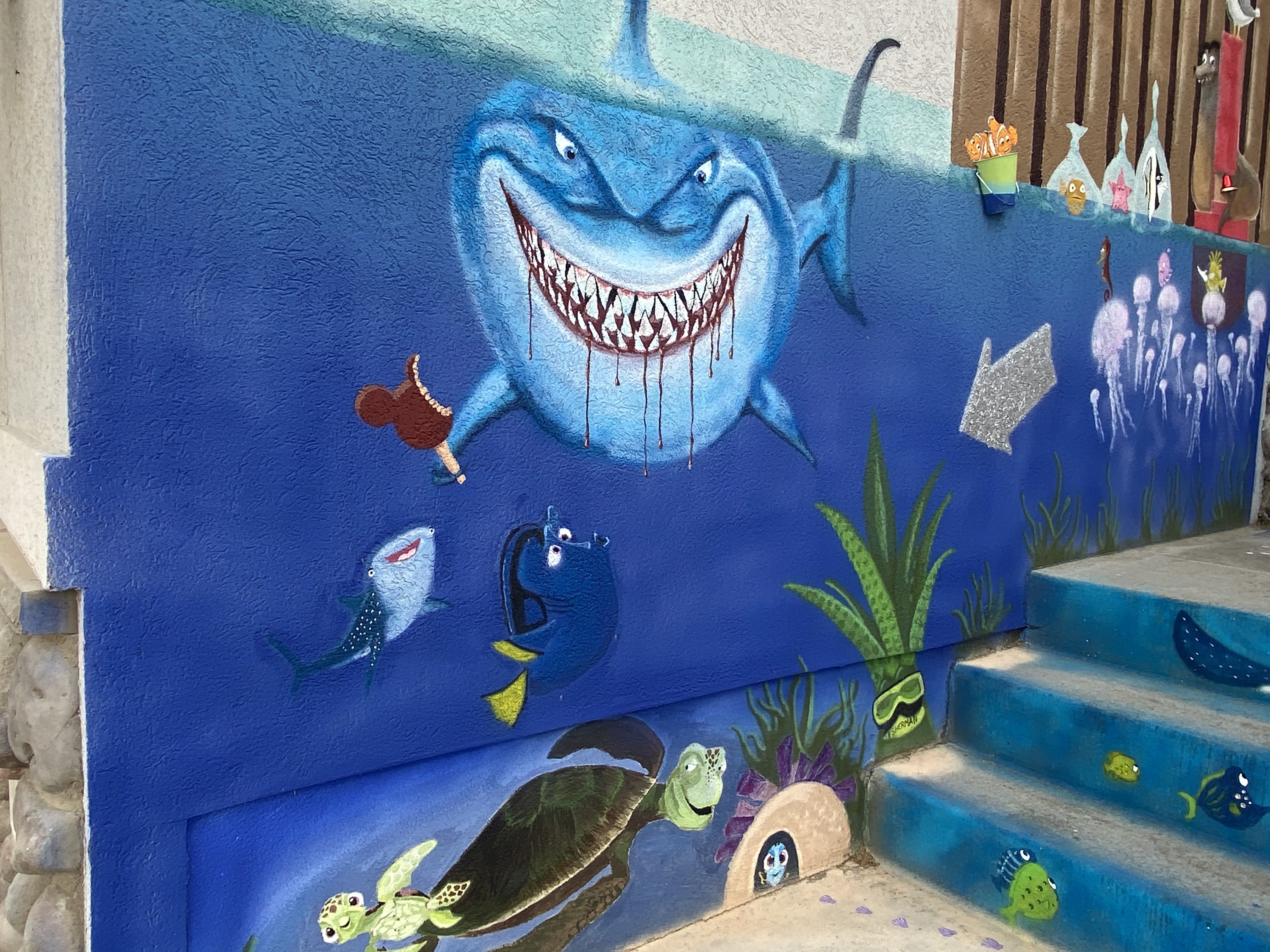 Clinton man Kelly Hertel has transformed his front yard into the Magic Kingdom. Here, characters from Finding Nemo swim near his front steps.