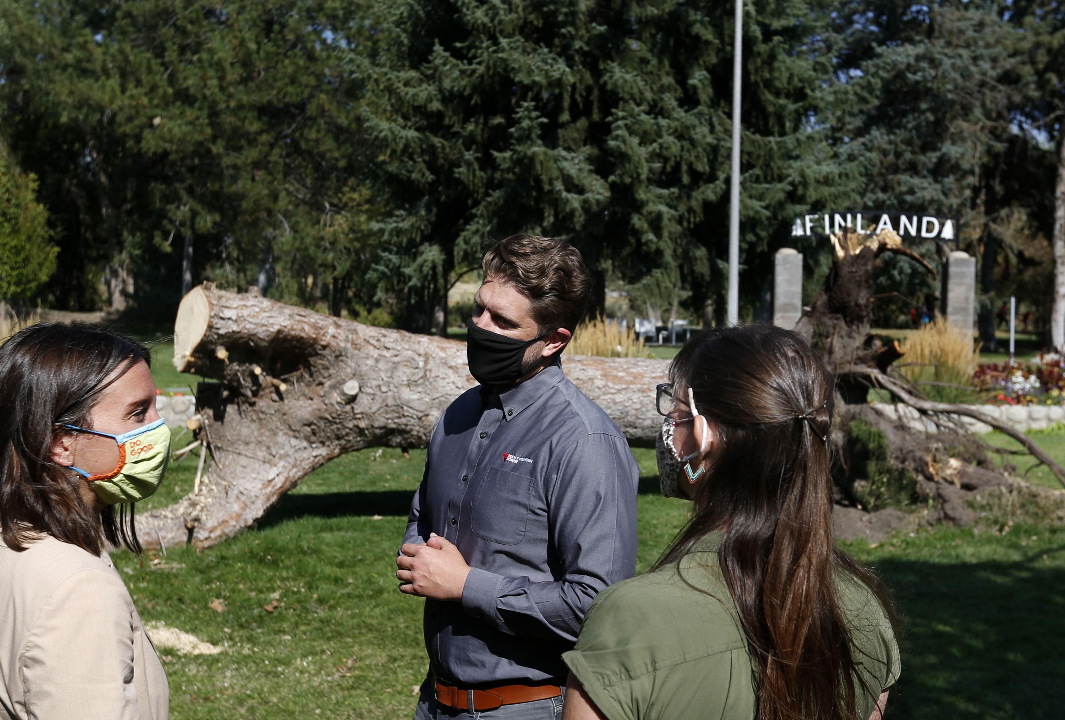 Salt Lake City Mayor Erin Mendenhall, left, Rocky Mountain Power's spokesperson Spencer Hall and TreeUtah Executive Director Amy May chat after a press conference at the International Peace Gardens in Salt Lake City on Thursday, Sept. 24, 2020, announcing a new effort to replant trees throughout the city that were lost in a Sept. 8 windstorm.