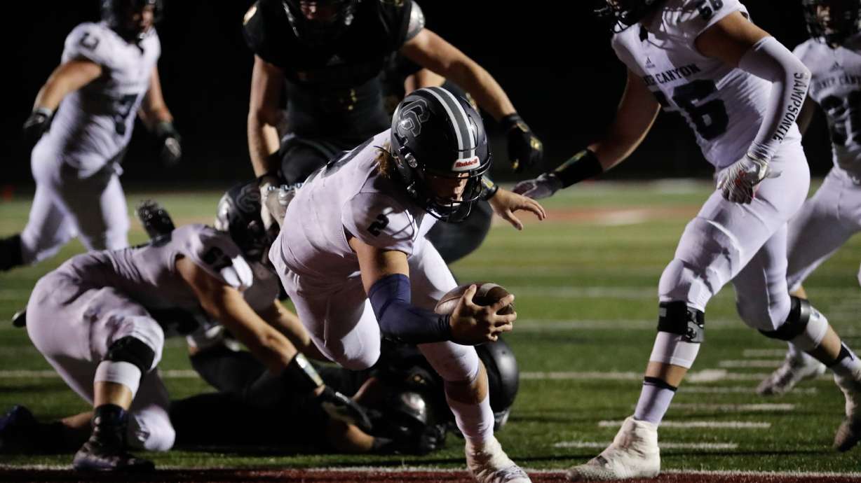 Corner Canyon's Jaxson Dart (2) carries the ball into the end zone for a touchdown during a high school football game at Lone Peak High School in Highland on Thursday, Sept. 24, 2020.