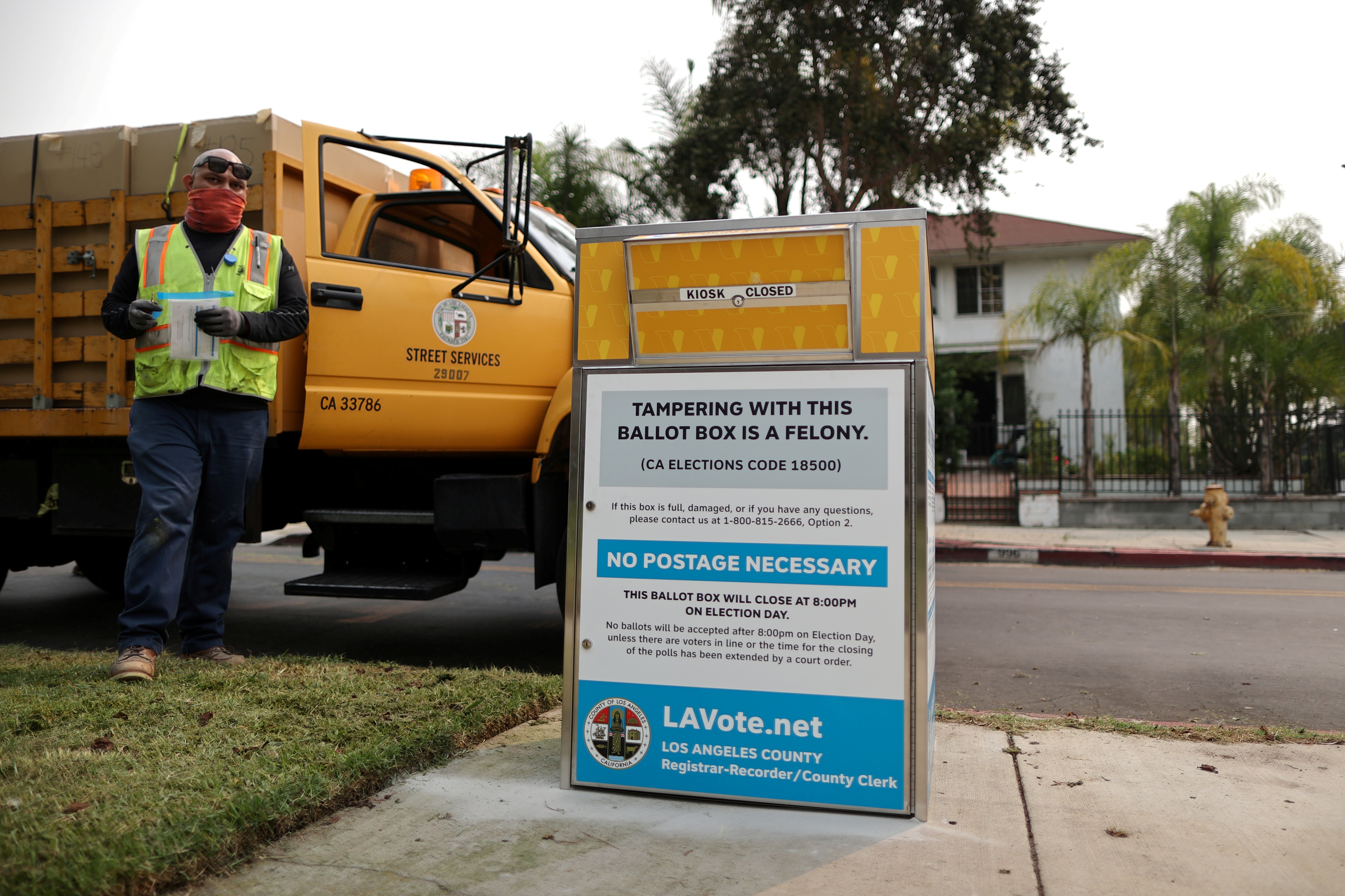 FILE PHOTO: StreetsLA workers install one of 123 Vote by Mail Drop Boxes outside a public library, amid the global outbreak of the coronavirus disease (COVID-19), in Los Angeles, California, U.S., September 11, 2020.