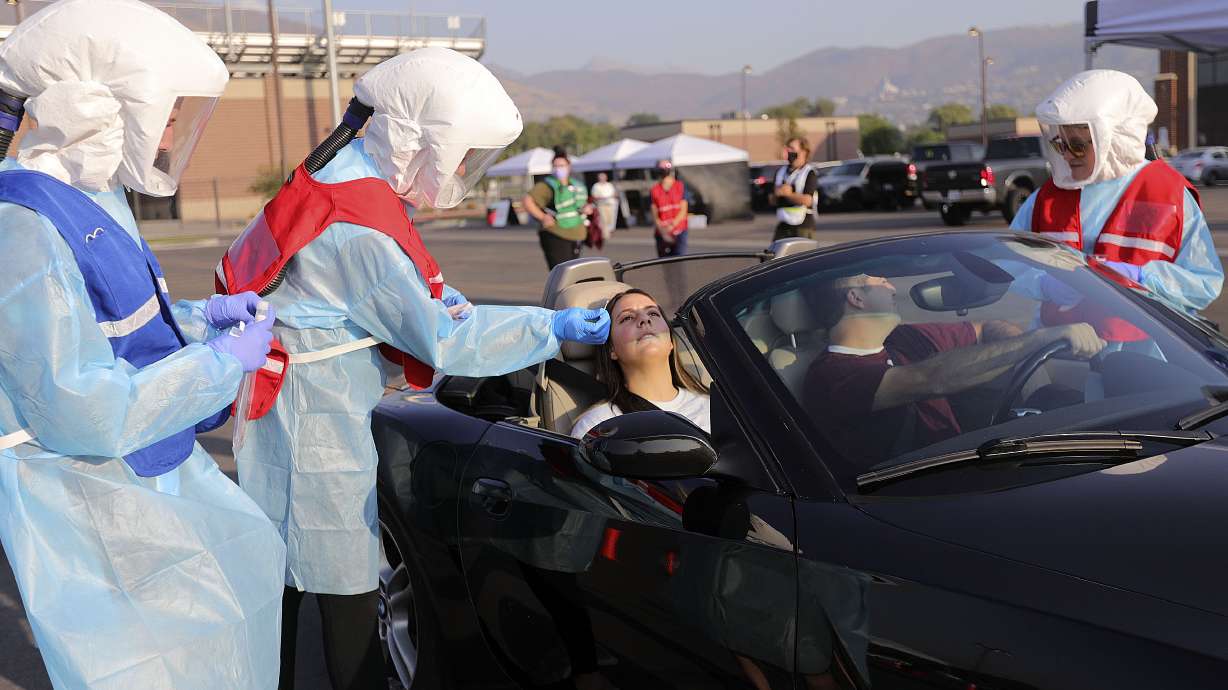Corner Canyon sophomore Megan Anselmo and her father Matt Anselmo get tested for COVID-19 outside of Corner Canyon High School in Draper on Monday, Sept. 21, 2020. The Salt Lake County Health Department will be offering COVID-19 testing at Corner Canyon High School again on Monday, Sept. 28, from 4 p.m. to 7 p.m.
