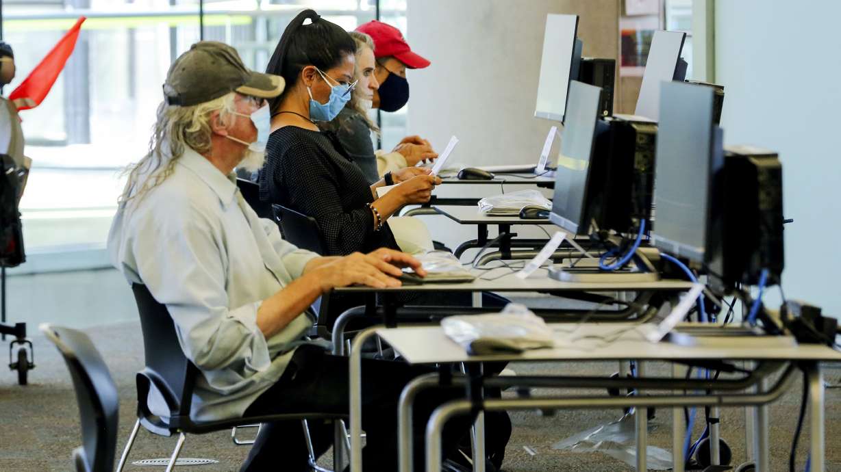 Patrons use computers at the Main Library in Salt Lake City on Monday, Sept. 21, 2020. All branches of the Salt Lake City Public Library reopened Monday for express services, which include 30-minute computer sessions, access to fax/copy machines, holds pickup, item return and reference assistance.