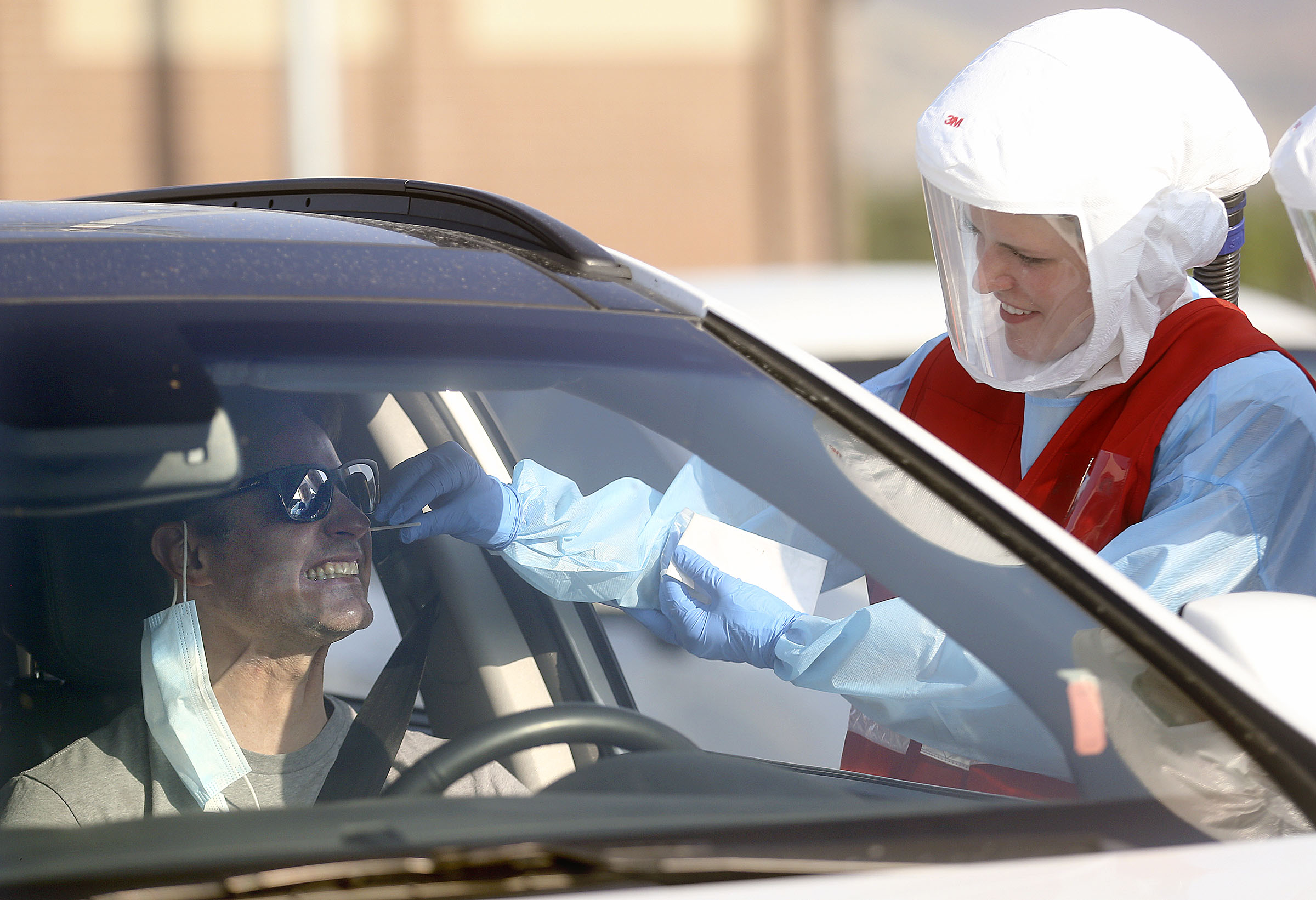 Chad Smith reacts as Sara Haight, Salt Lake County Health Department R.N., tests him for COVID-19 outside of Corner Canyon High School in Draper on Monday, Sept. 21, 2020. The Salt Lake County Health Department will be offering COVID-19 testing at Corner Canyon High School again on Monday, Sept. 28, from 4 p.m. to 7 p.m.