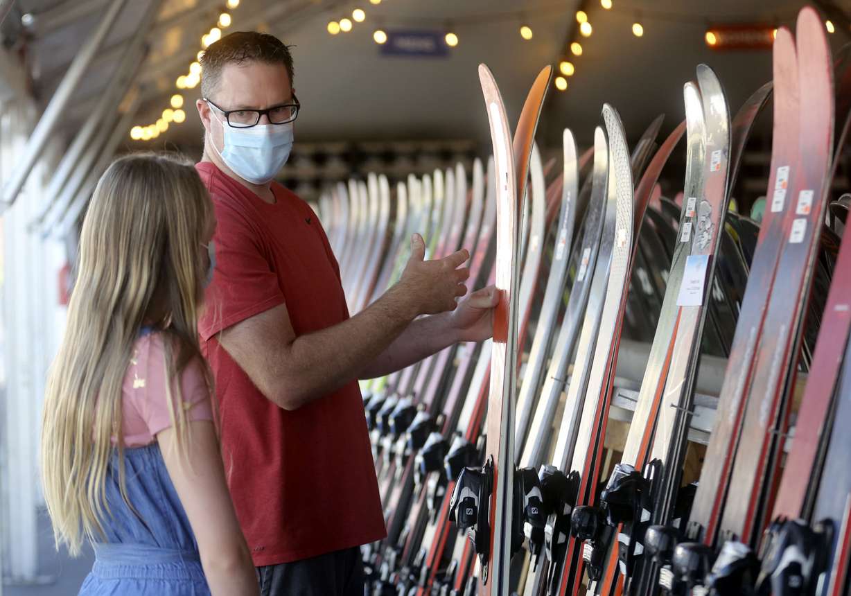 Kaylee Swensen and Scott Swensen look at skis while shopping at Ski âN Seeâs annual sale in the parking lot outside of Ski âN See in Sandy on Friday, Sept. 4, 2020.