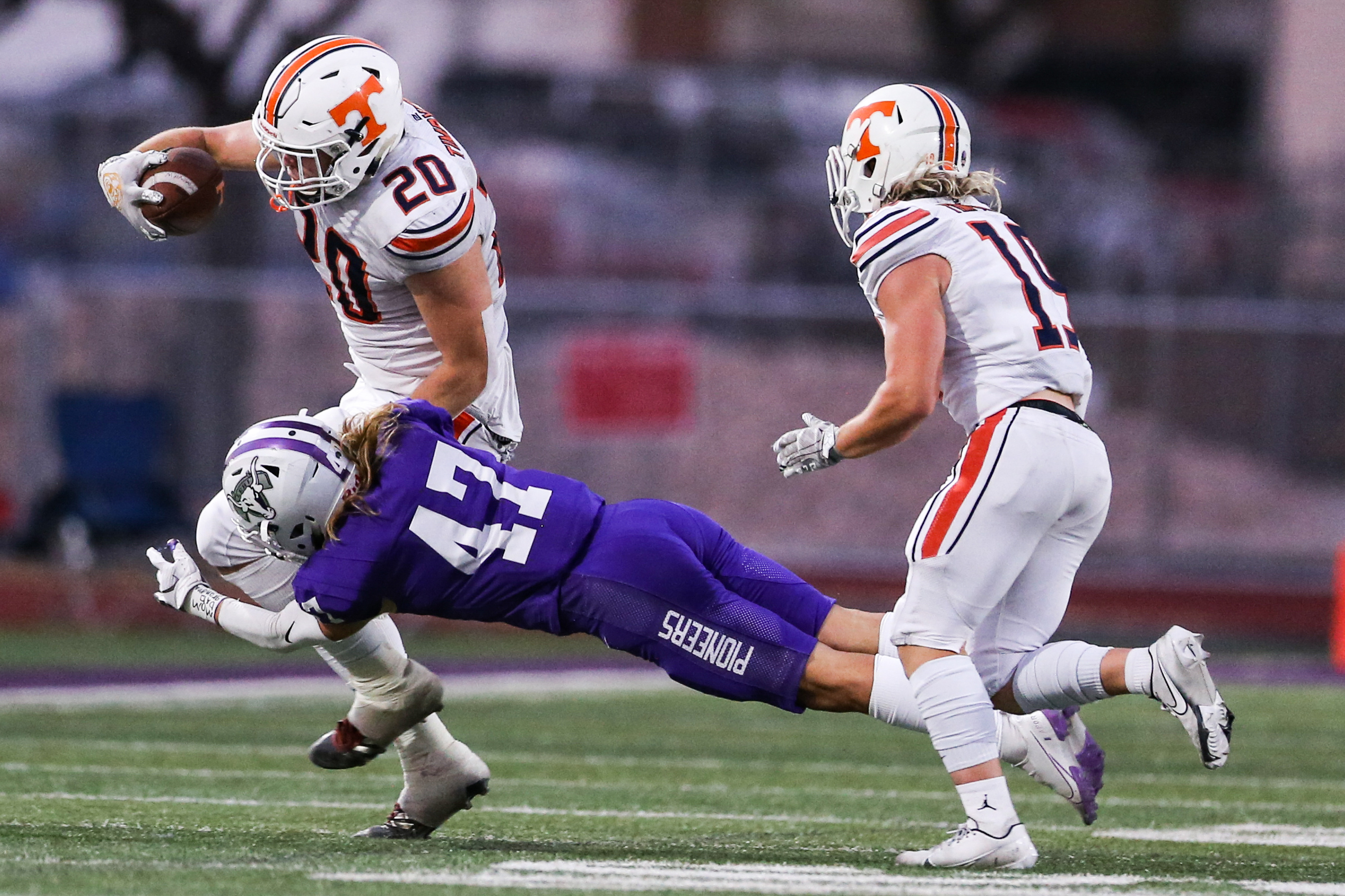 Timpview's Carsen Ryan (20) carries the ball against the Lehi defense during a high school football game at Lehi High School in Lehi on Friday, Sept. 25, 2020.