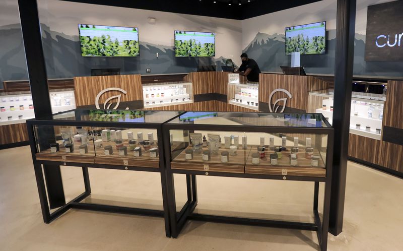 Pharmacist Nadia Lian and assistant manager Fabian Camarena work at Curaleaf, a cannabis dispensary, in Lehi on Wednesday, Sept. 23, 2020.