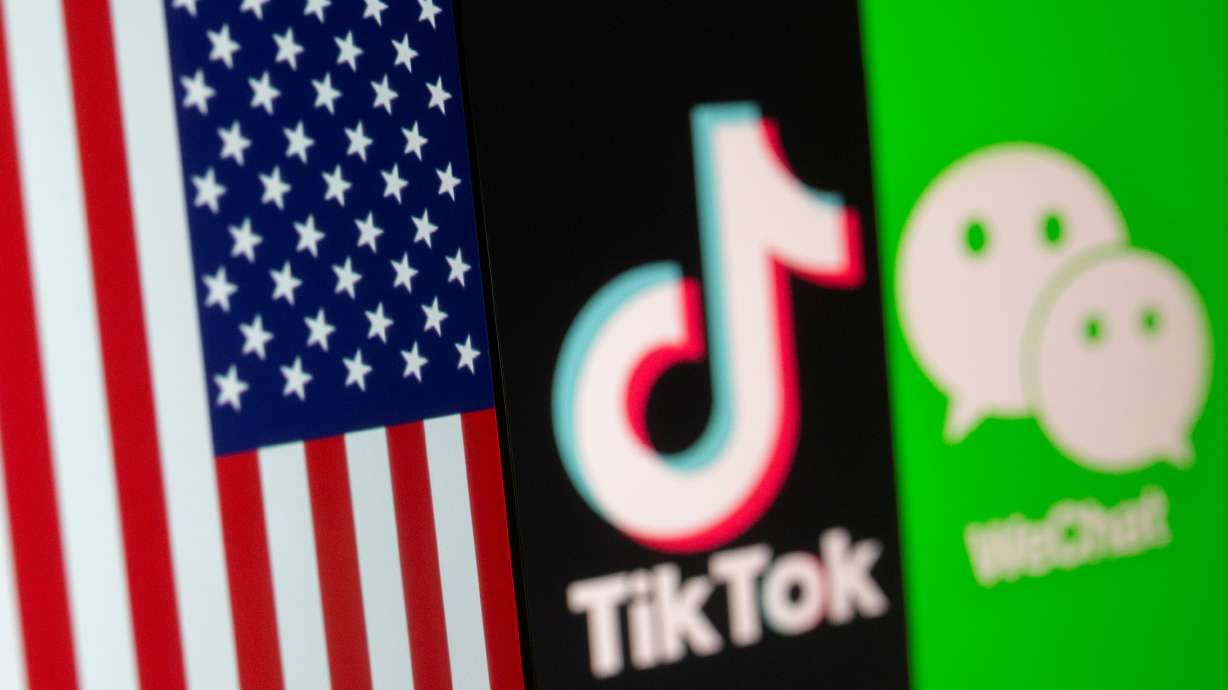 FILE PHOTO: A U.S. flag is seen on a smartphone in front of displayed Tik Tok and WeChat logos in this illustration taken September 18, 2020. REUTERS/Dado Ruvic/Illustration