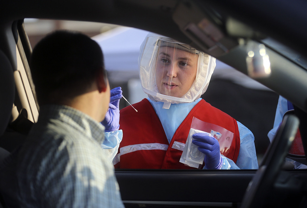 Maya Rockwell talks to Adam Hunter before testing him for COVID-19 outside of Corner Canyon High School in Draper on Monday, Sept. 21, 2020. The Salt Lake County Health Department will be offering COVID-19 testing at Corner Canyon High School again on Monday, Sept. 28, from 4 p.m. to 7 p.m.