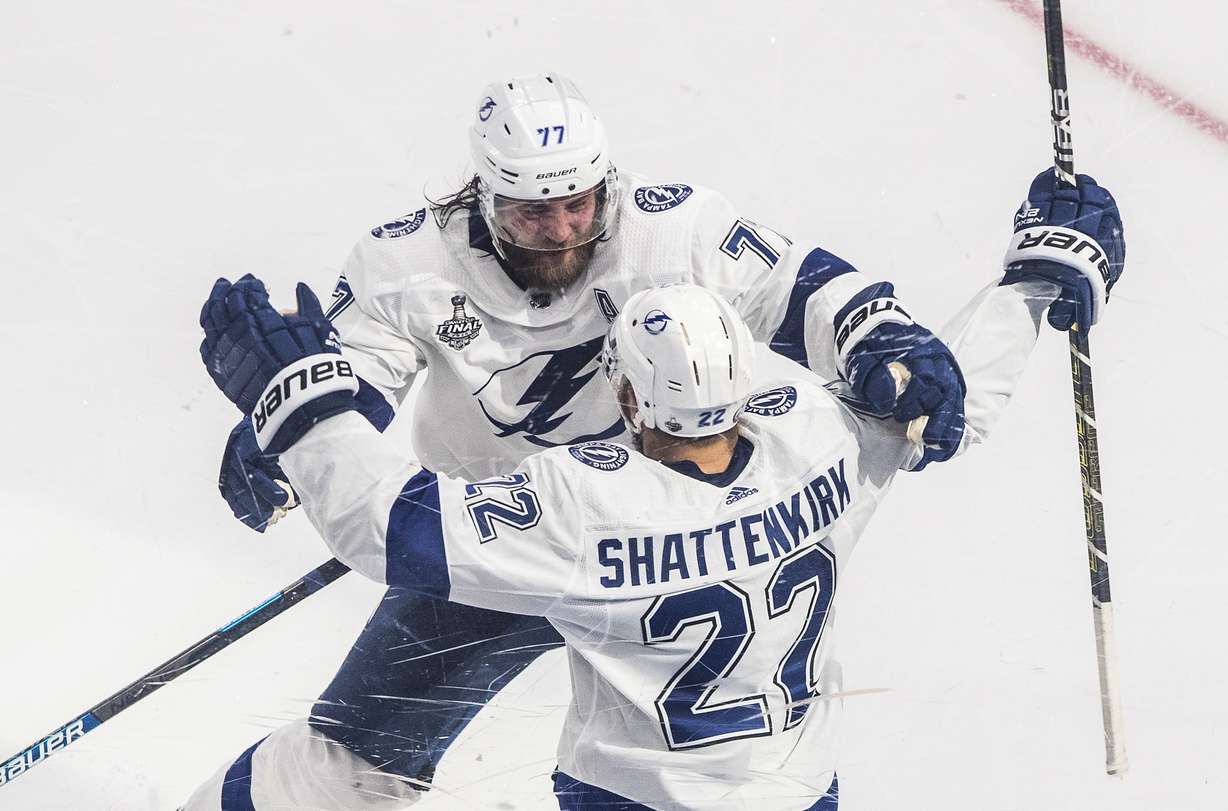 Tampa Bay Lightning defenseman Kevin Shattenkirk (22) celebrates his goal against the Dallas Stars with Victor Hedman (77) during overtime in Game 4 of the NHL hockey Stanley Cup Final, Friday, Sept. 25, 2020, in Edmonton, Alberta.