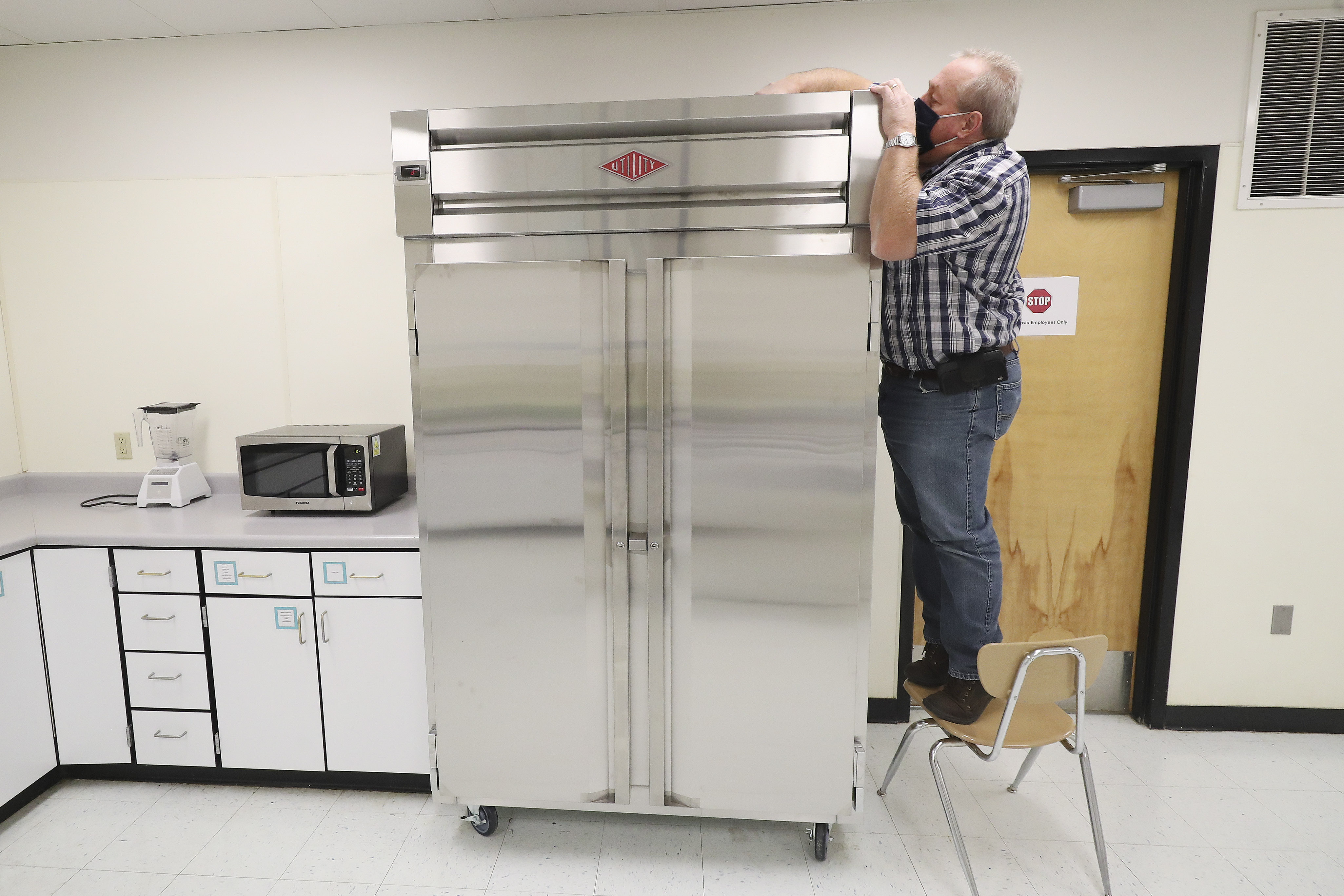 Layton High School facilities coordinator Rod Southam adjusts the temperature of a refrigerator at the school in Layton on Tuesday, Sept. 29, 2020. Southam is the winner of the national U.S. Department of Education RISE award, which honors classified school employees who exemplify excellence in work performance, leadership and community involvement.