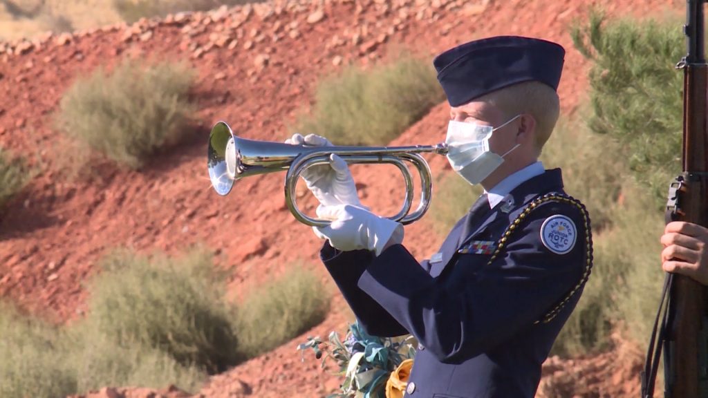 An ROTC cadet performs taps at the funeral for Senior Master Sergeant Morgan Hager.