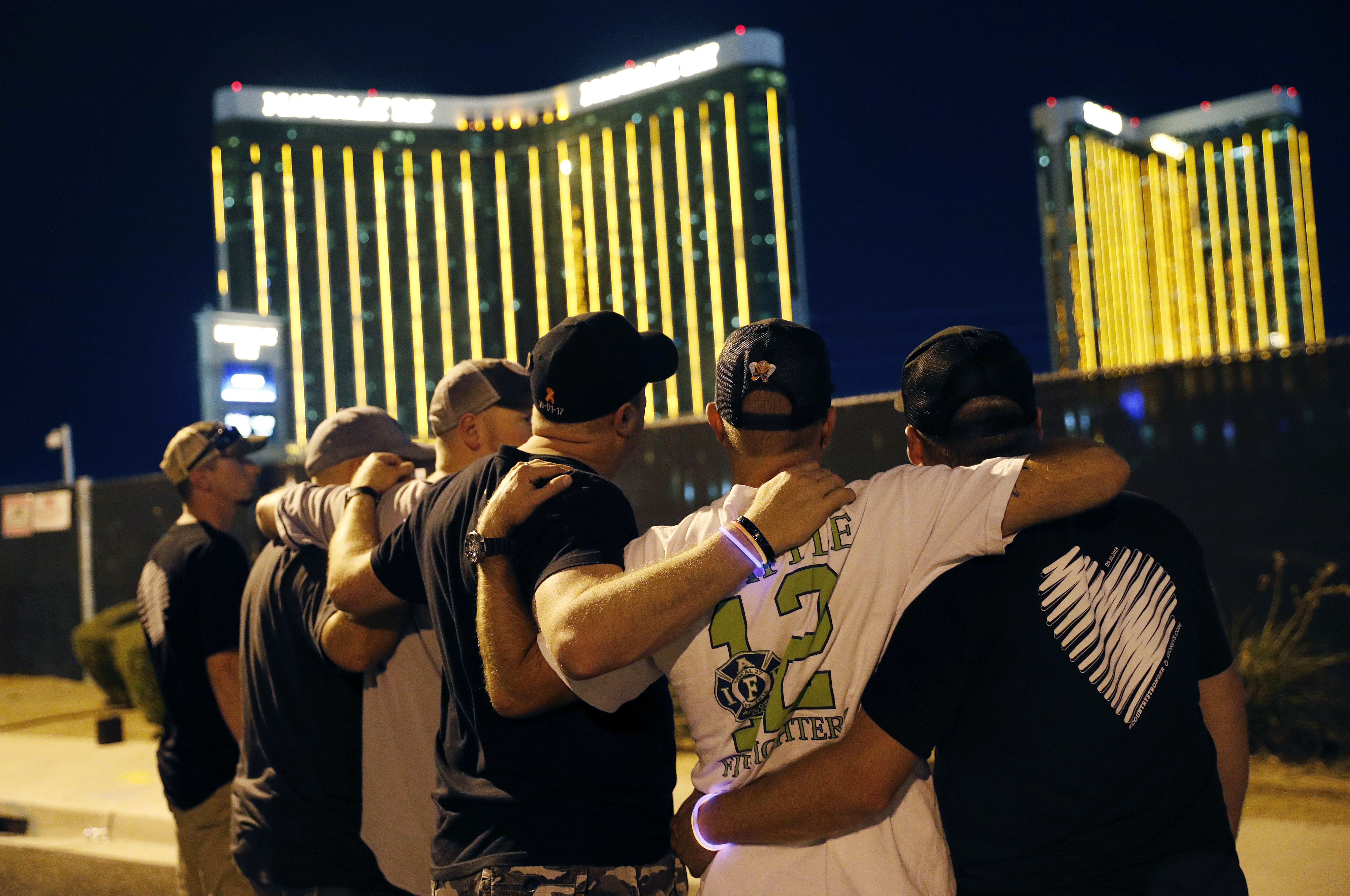 FILE - In this Oct. 1, 2018, file photo, survivors return to the scene of a mass shooting on the first anniversary in Las Vegas. A judge in Nevada has approved a total of $800 million in payouts from casino company MGM Resorts International and its insurers to more than 4,400 relatives and victims of the Las Vegas Strip shooting that was the deadliest in recent U.S. history. (AP Photo/John Locher, File) [Sep-30-2020]