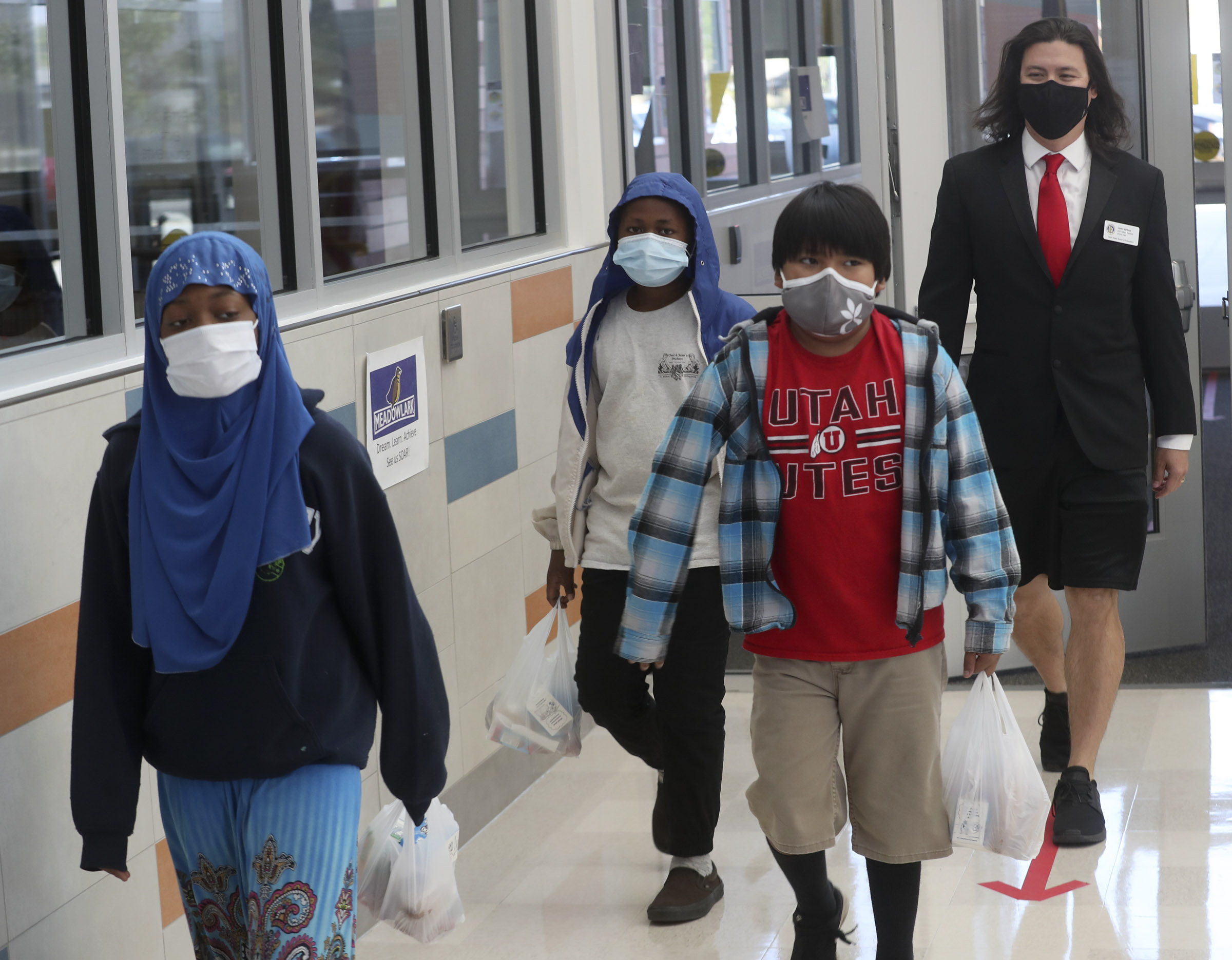 John Arthur, Utah's Teacher of the Year, back, walks with a few of his sixth grade students after they grabbed their lunches at Meadowlark Elementary School in Salt Lake City on Thursday, Oct. 1, 2020.