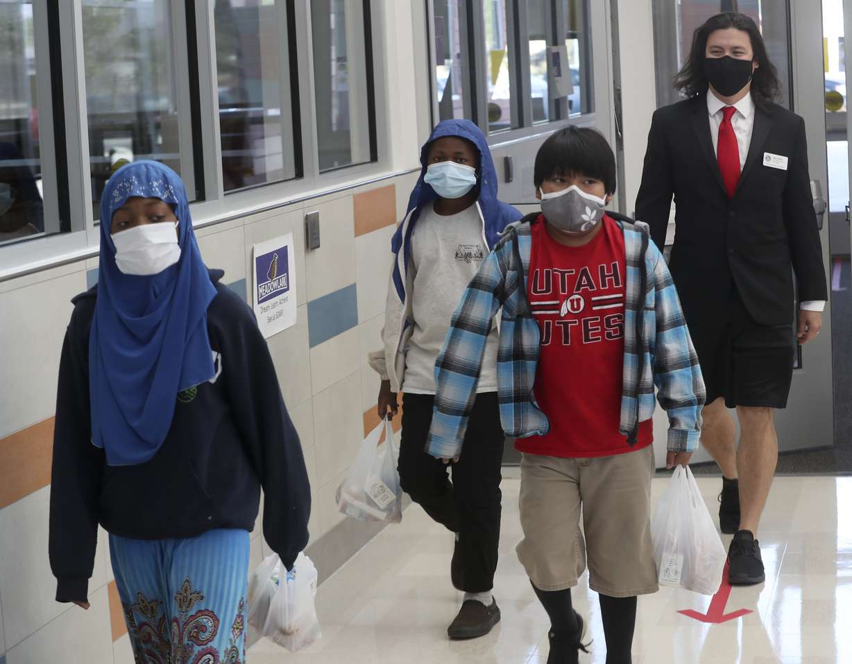 John Arthur, Utah's Teacher of the Year, back, walks with a few of his sixth grade students after they grabbed their lunches at Meadowlark Elementary School in Salt Lake City on Thursday, Oct. 1, 2020.