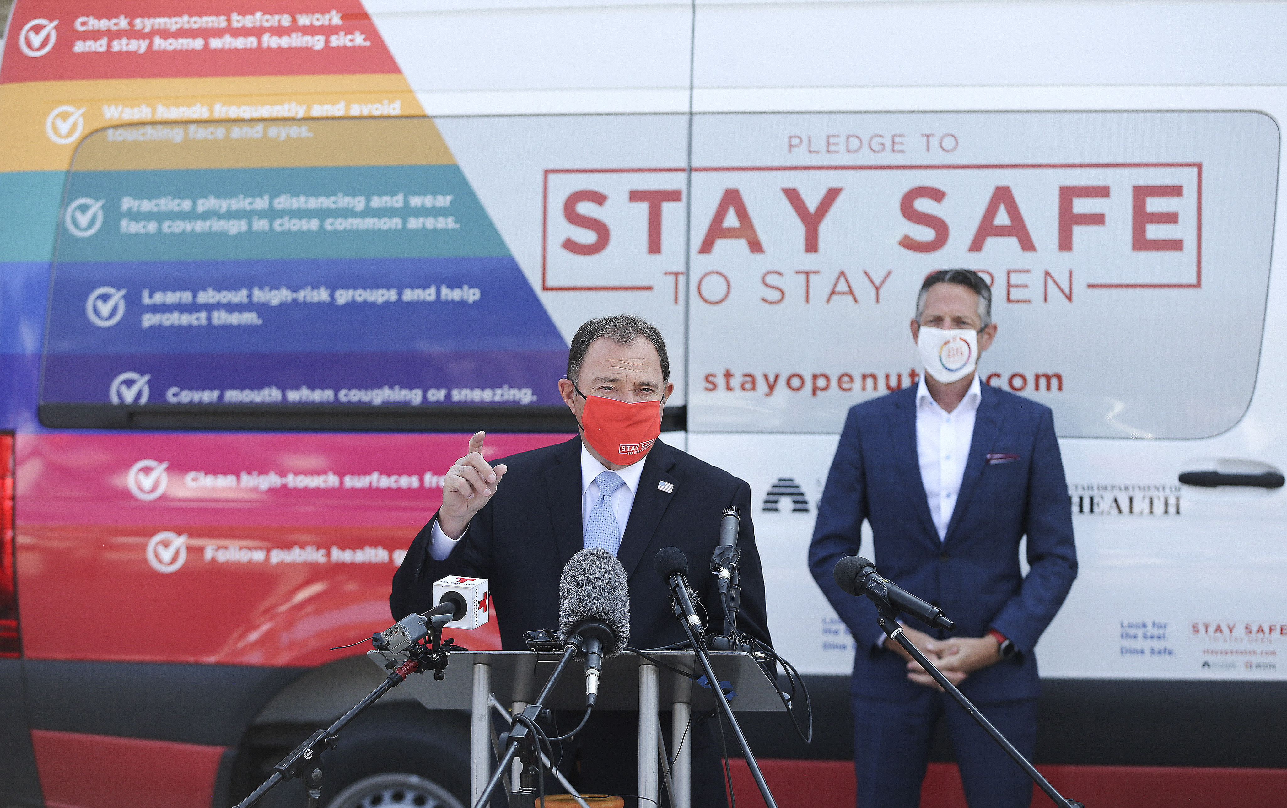 Gov. Gary Herbert speaks as the Salt Lake Chamber and Utah Department of Health introduce the "Stay Safe to Stay Open" campaign at a Smith's parking lot in Salt Lake City on Thursday, Oct. 1, 2020. Chamber President Derek Miller listens in the background.