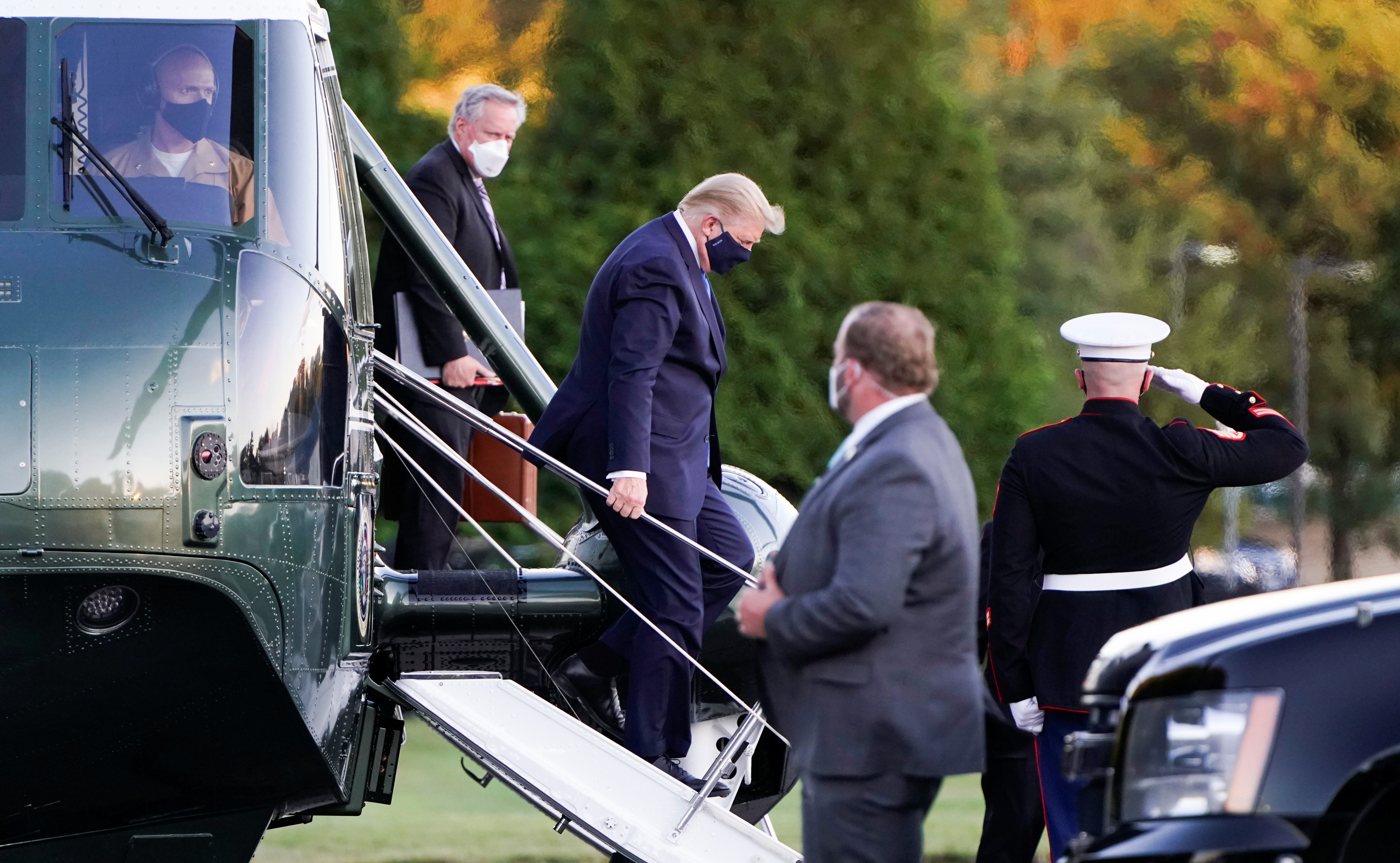 U.S. President Donald Trump disembarks from the Marine One helicopter followed by White House Chief of Staff Mark Meadows as he arrives at Walter Reed National Military Medical Center after the White House announced that he "will be working from the presidential offices at Walter Reed for the next few days" after testing positive for the coronavirus disease (COVID-19), in Bethesda, Maryland, U.S., Oct. 2, 2020. REUTERS/Joshua Roberts