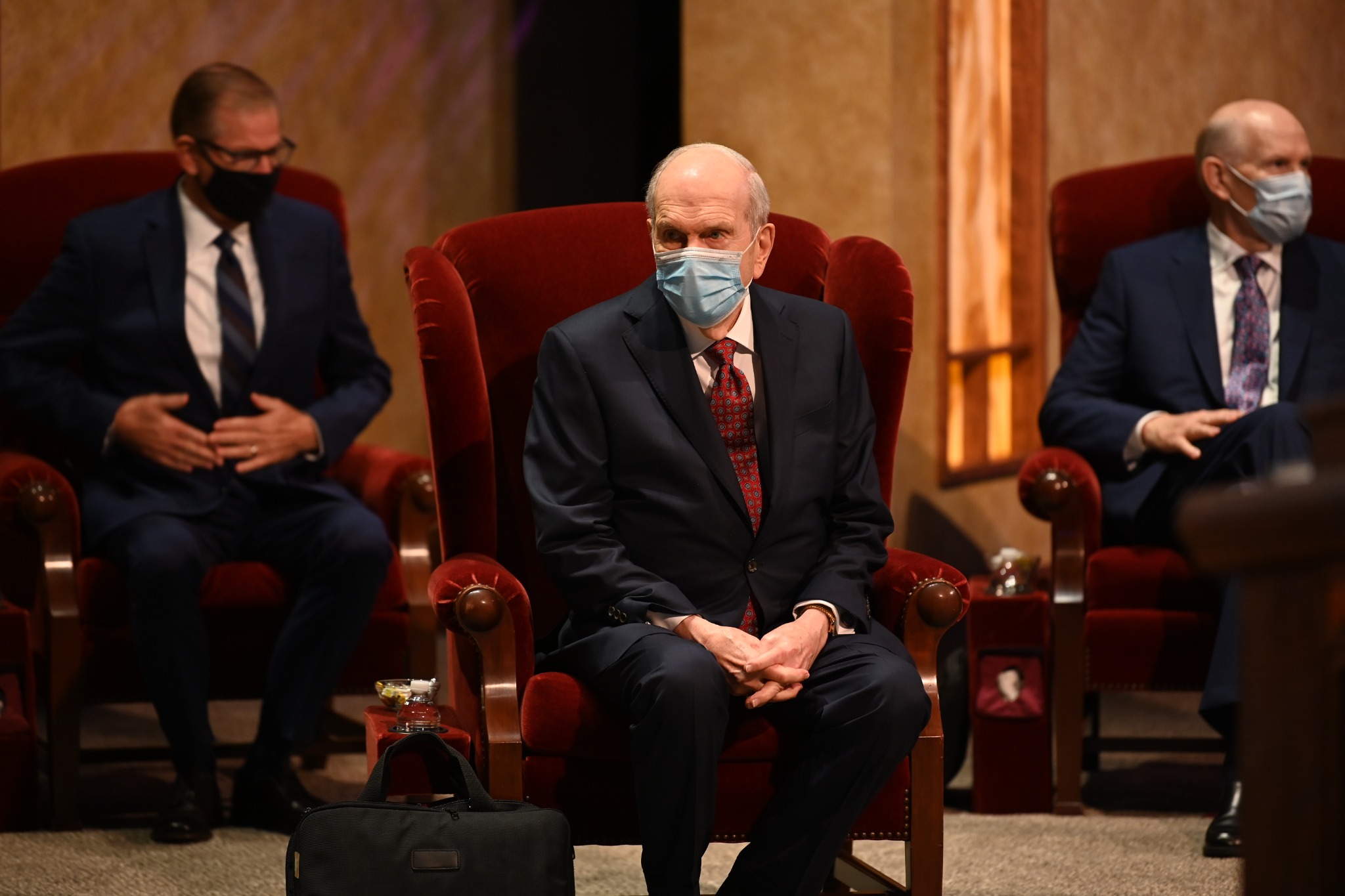 President Nelson waits for the broadcast to start, with Elder Stevenson and Elder Renlund in the background at the Conference Center Theater on Temple Square, October 2020 conference (October 3–4, 2020)
