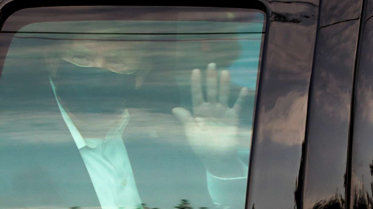 U.S. President Donald Trump waves to supporters as he briefly rides by in the presidential motorcade in front of Walter Reed National Military Medical Center, where he is being treated for coronavirus disease (COVID-19) in Bethesda, Maryland, U.S. October 4, 2020.