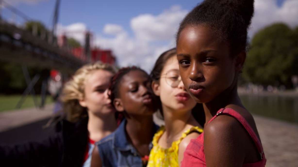 This image released by Netflix shows the cast of the coming-of-age film “Cuties.” The backlash to the French independent film “Mignonnes,” or “Cuties,” started before it had even been released because of a poster that went viral for its provocative depiction of its young female actors.