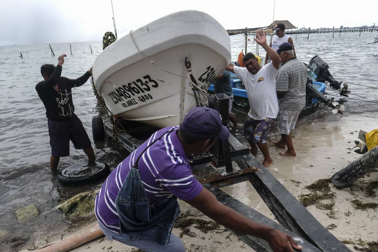 Fishermen pull in a boat before the arrival of Hurricane Delta in Puerto Juarez, Cancun, Mexico, Tuesday, Oct. 6, 2020. Hurricane Delta rapidly intensified into a potentially catastrophic Category 4 hurricane Tuesday on a course to hammer southeastern Mexico and then continue on to the U.S. Gulf coast this week.