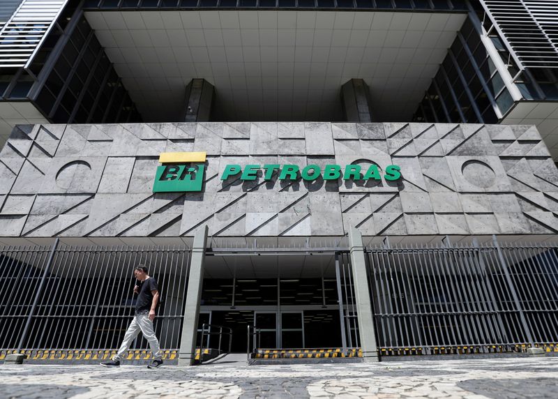 FILE PHOTO: A man walks in front of the headquarters of Petroleo Brasileiro S.A. (Petrobas) in Rio de Janeiro, Brazil March 9, 2020. REUTERS/Sergio Moraes/File Photo