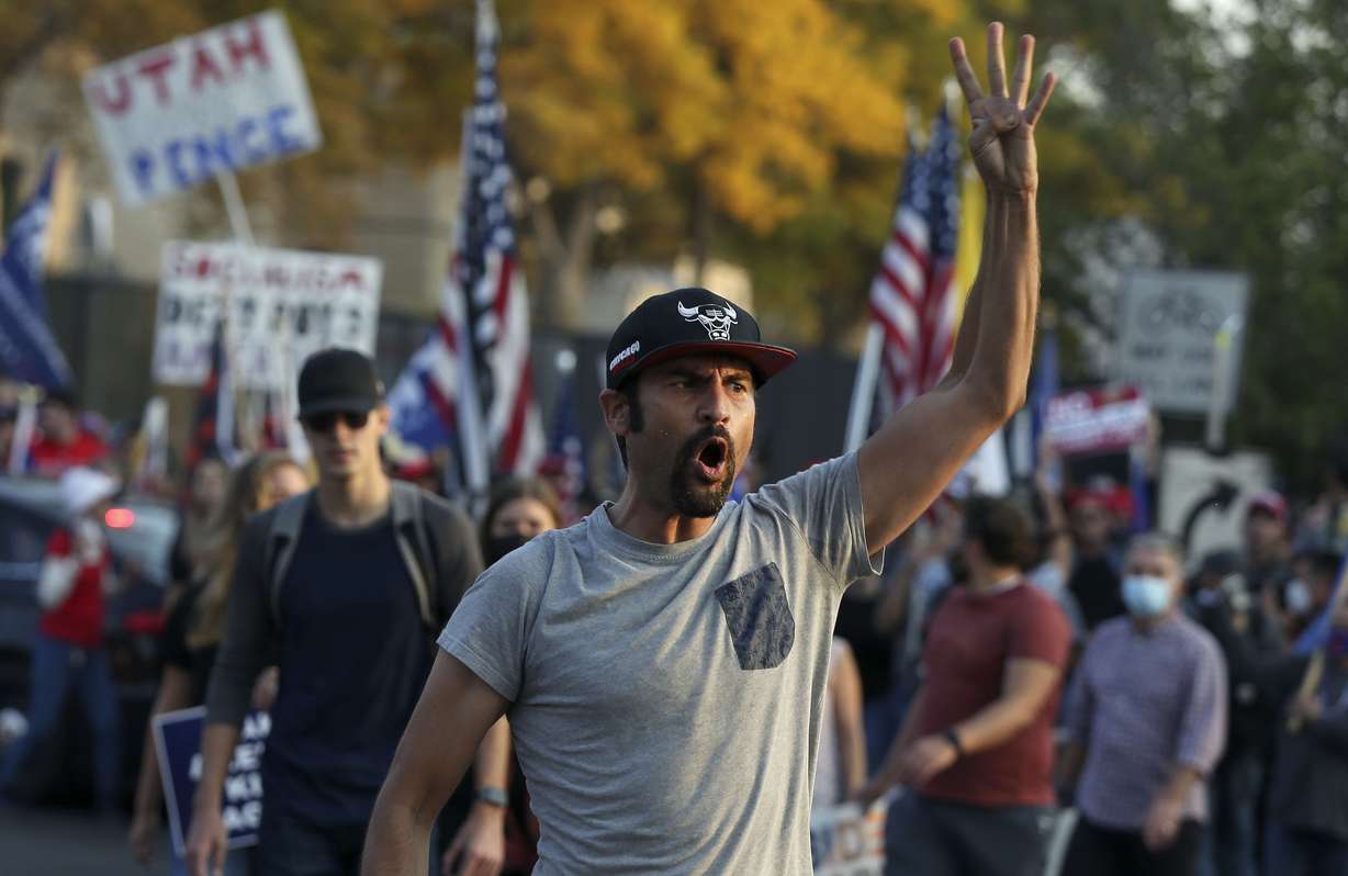 A Biden supporter chants "four more weeks" prior to the vice presidential debate between Vice President Mike Pence and his Democratic rival, California Sen. Kamala Harris, at the University of Utah in Salt Lake City on Wednesday, Oct. 7, 2020.