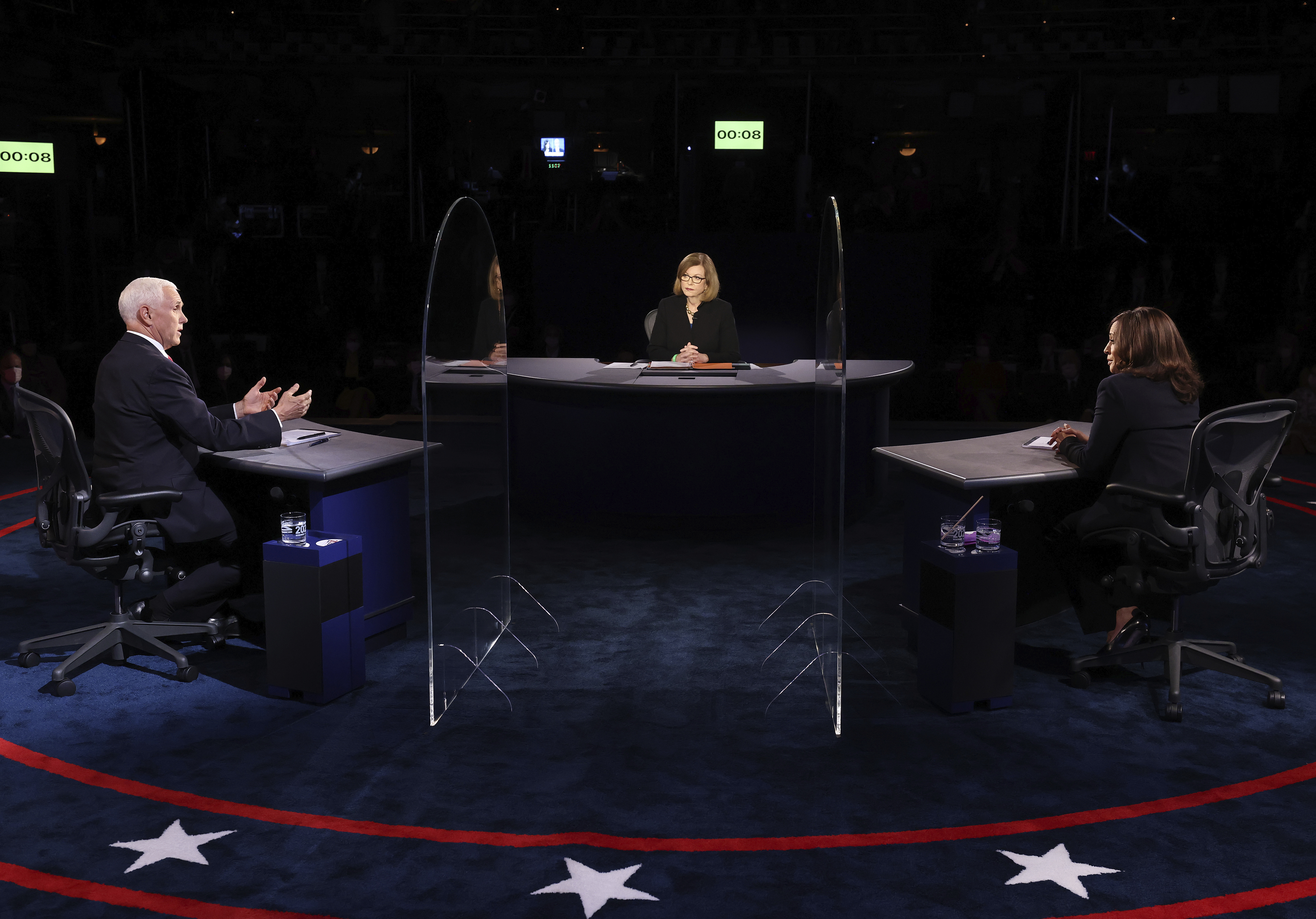 Vice President Mike Pence speaks as Democratic vice presidential candidate Sen. Kamala Harris, D-Calif., listens during the vice presidential debate Wednesday, Oct. 7, 2020, at Kingsbury Hall on the campus of the University of Utah in Salt Lake City. (Justin Sullivan/Pool via AP) [Oct-07-2020]
