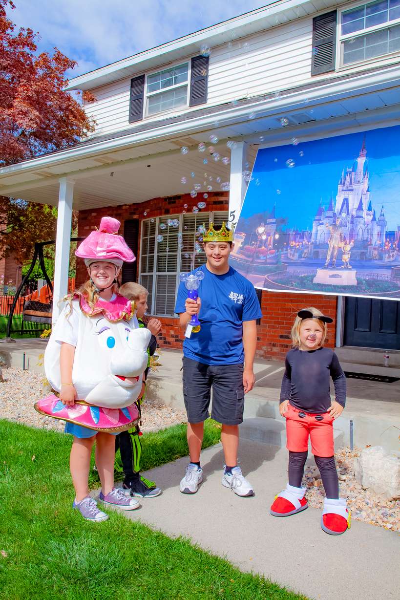 To celebrate, Kai Papenfuss's neighbors dressed up as Disney characters, paraded through the neighborhood, and welcomed him across the finish line to Disney's iconic castle in his own front driveway.