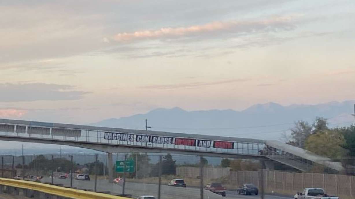 Anti-vaccination signs over freeway deemed a distraction, taken down