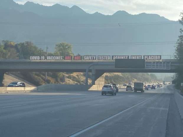 Drivers along I-215 saw signs saying “Vaccines can cause injury and death,” “COVID-19 vaccines are not safety tested against inert placebo,” and “Vaccine makers are exempt from liability.”